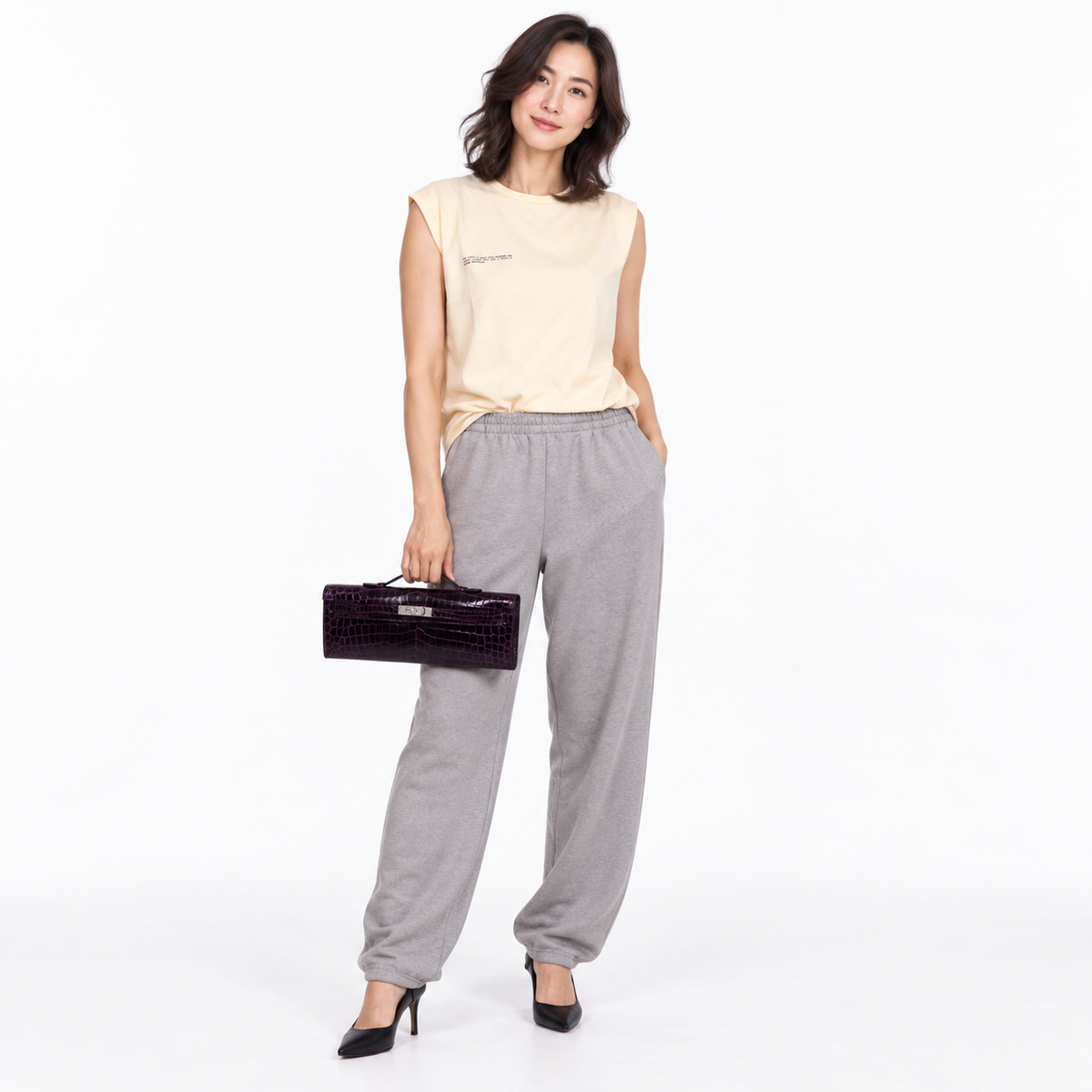 Hermès Kelly Cut Aubergine Shiny Niloticus Crocodile Palladium Hardware — styled on a human model