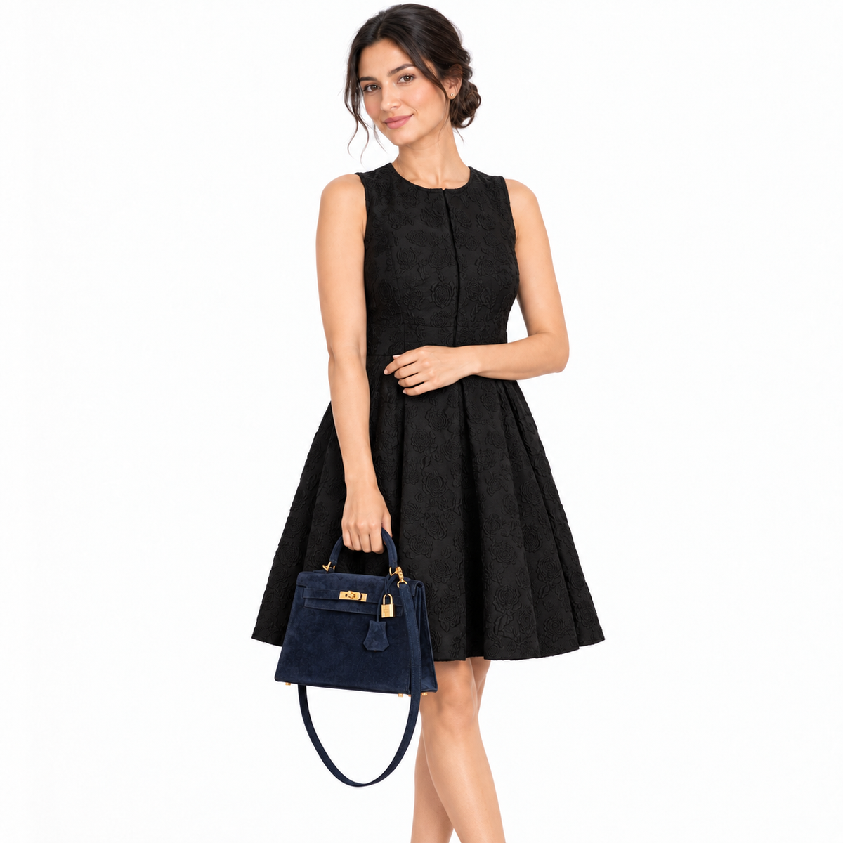 Hermès Kelly 25 Sellier Blue Sapphire Suede Gold Hardware hand carried by an adult model in a white studio