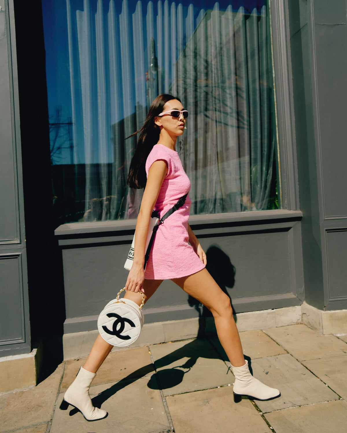 Chanel Round CC Vanity White and Black Patent Leather Gold Hardware, carried by a model in mid stride