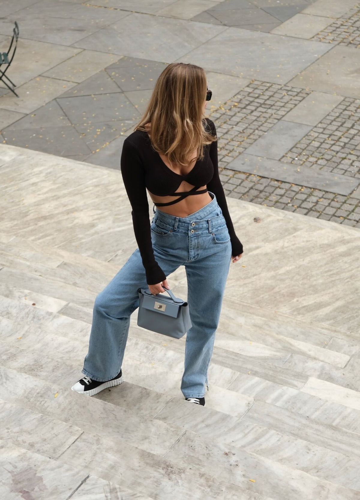 Hermès 24/24 21 Bleu Lin Evercolor/Swift Palladium Hardware, carried by a model on stone steps