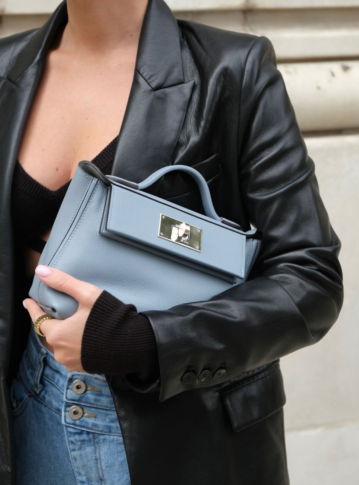 Hermès 24/24 21 Bleu Lin Evercolor/Swift Palladium Hardware, held under the arm by a model, front view