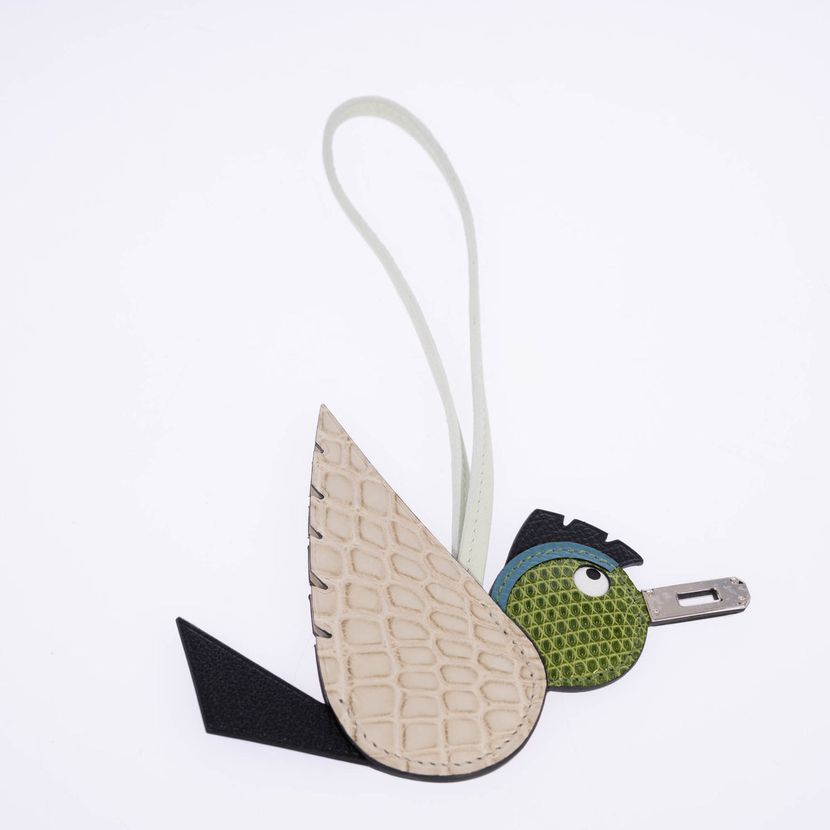 Hermès Birdy bag charm with a Béton alligator wing, Pelouse lizard head, Noir leather details and a palladium beak.