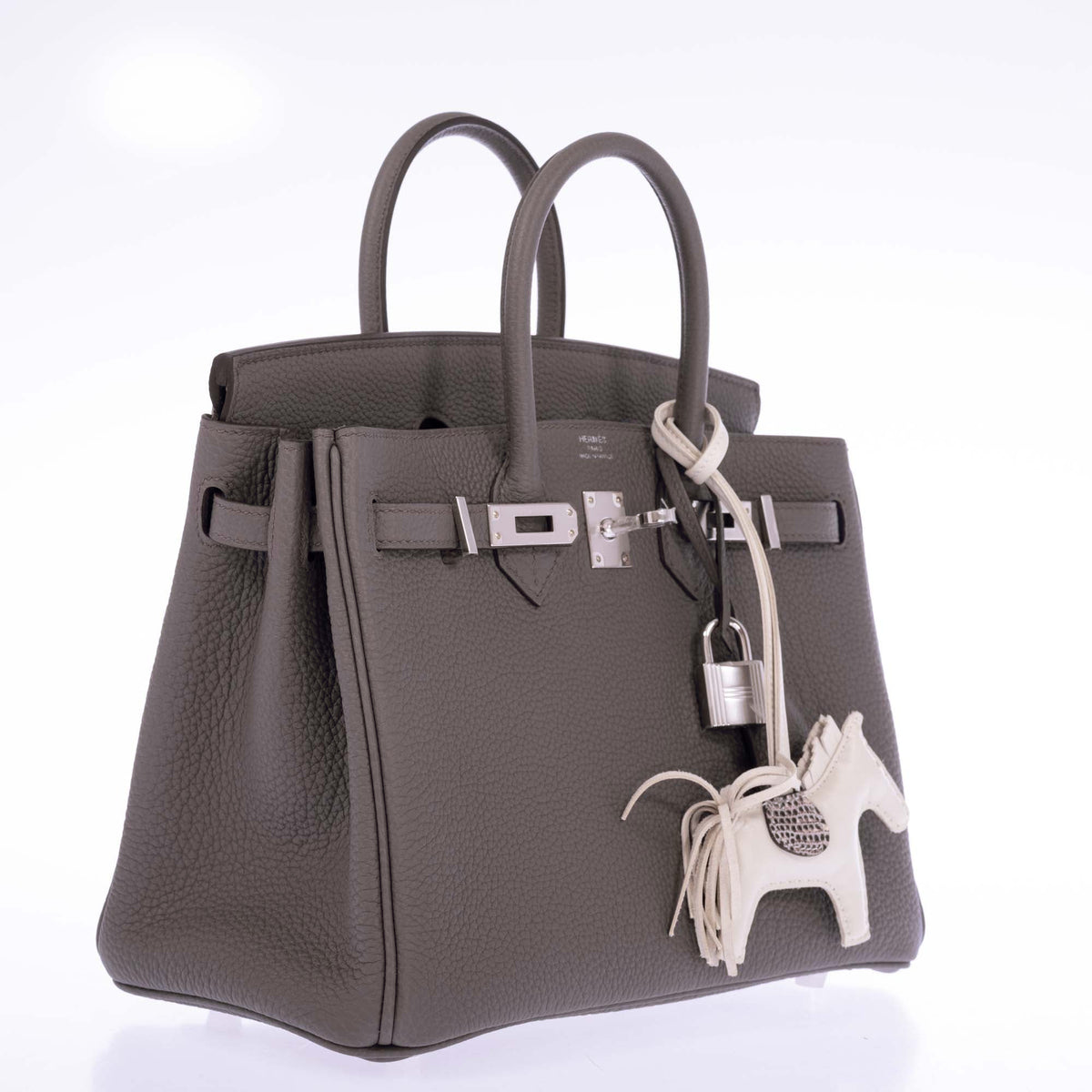 Hermès Birkin 25 Étain Togo Palladium Hardware, open three-quarter view with an ivory horse charm, sold separately.