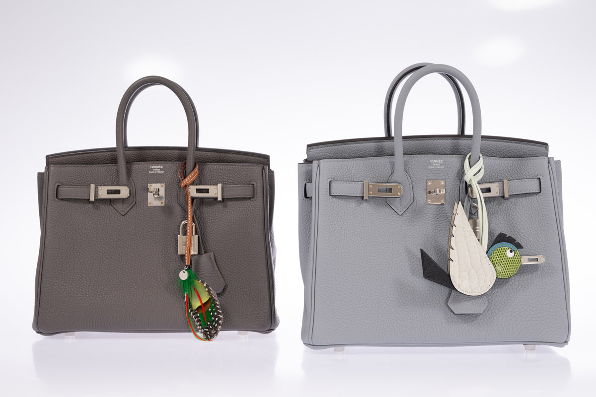 Hermès Birkin 25 Gris Meyer Togo Palladium Hardware, shown on the right with a bird charm beside another Birkin 25 with a feather charm, all sold separately