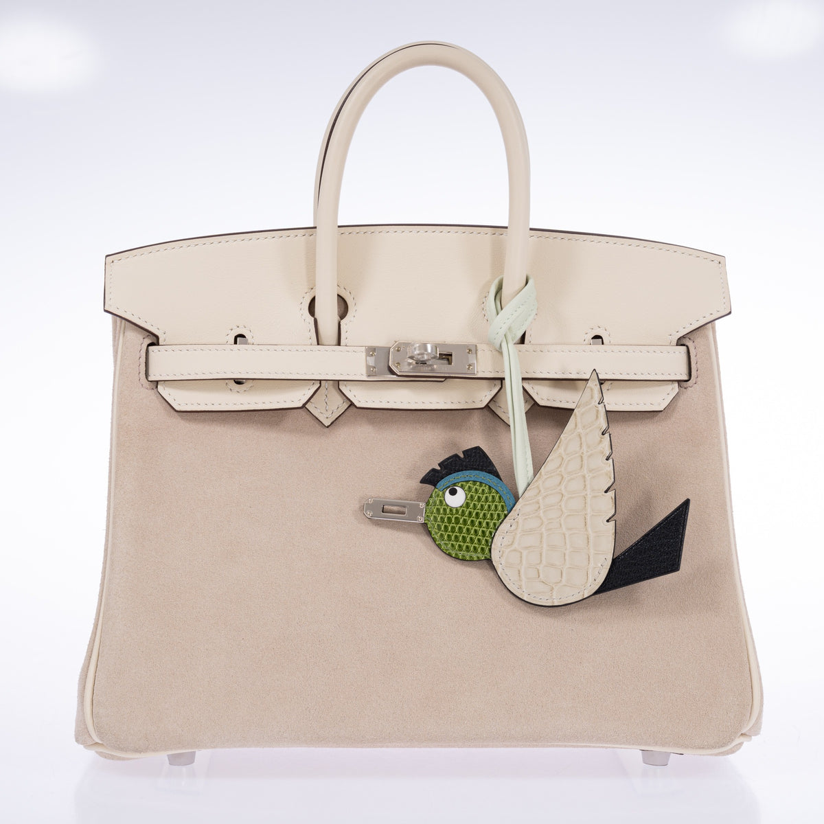 Béton, Noir and Pelouse Birdy charm attached to a closed Hermès Birkin 25 Grizzly Nata with palladium hardware.