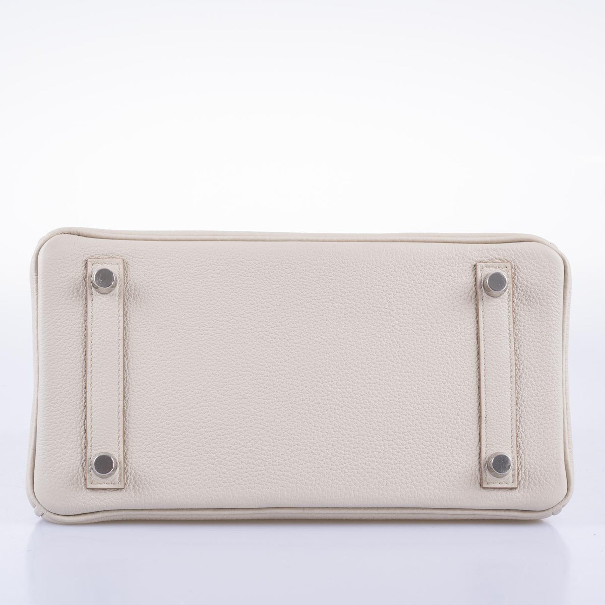 Hermès Birkin 25 Touch Béton, base view showing leather reinforcement strips and four palladium feet.