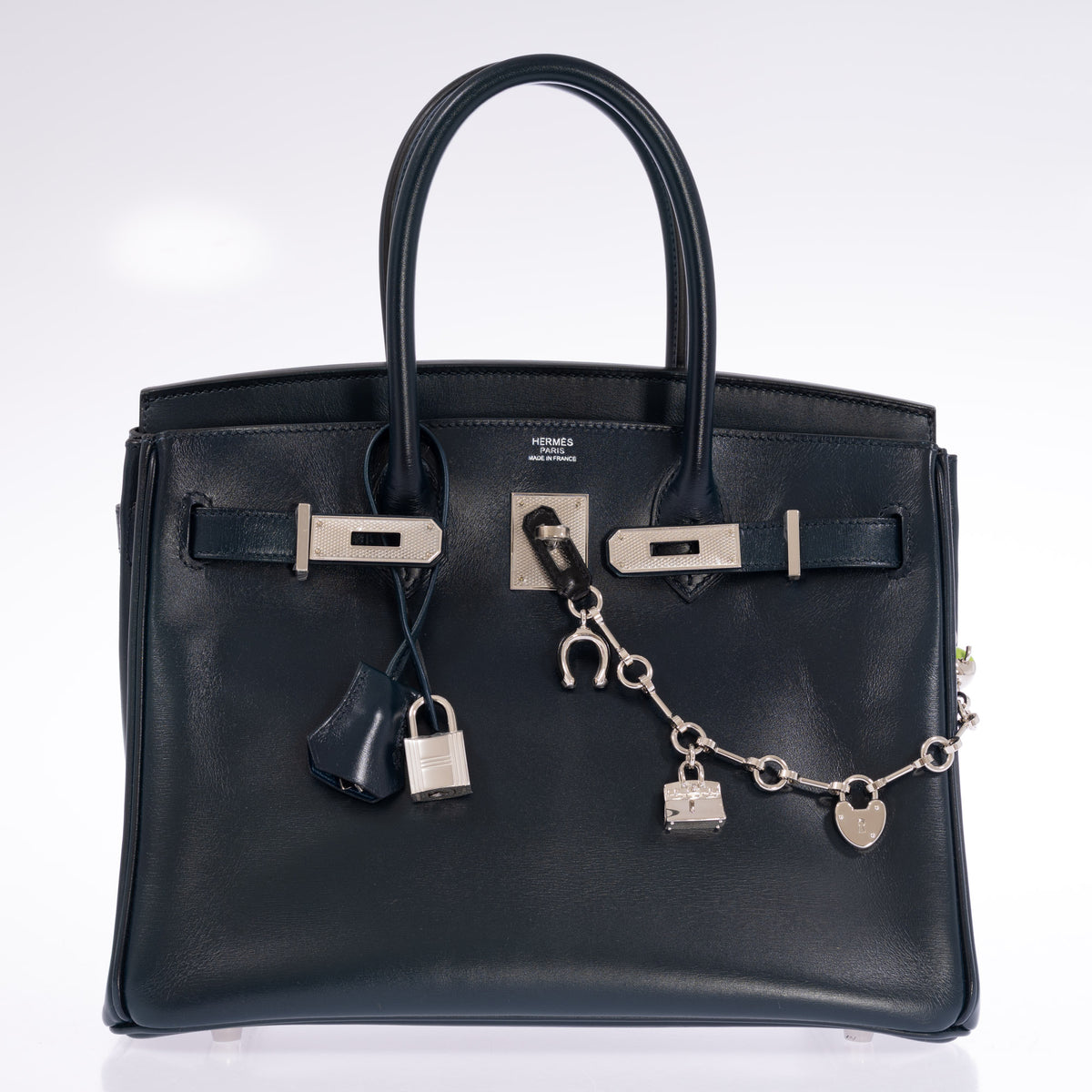 Hermès Birkin 30 Bleu de Prusse Box Calf Guilloche Palladium Hardware, front view with the flap open, padlock and clochette, styled with a charm chain, sold separately