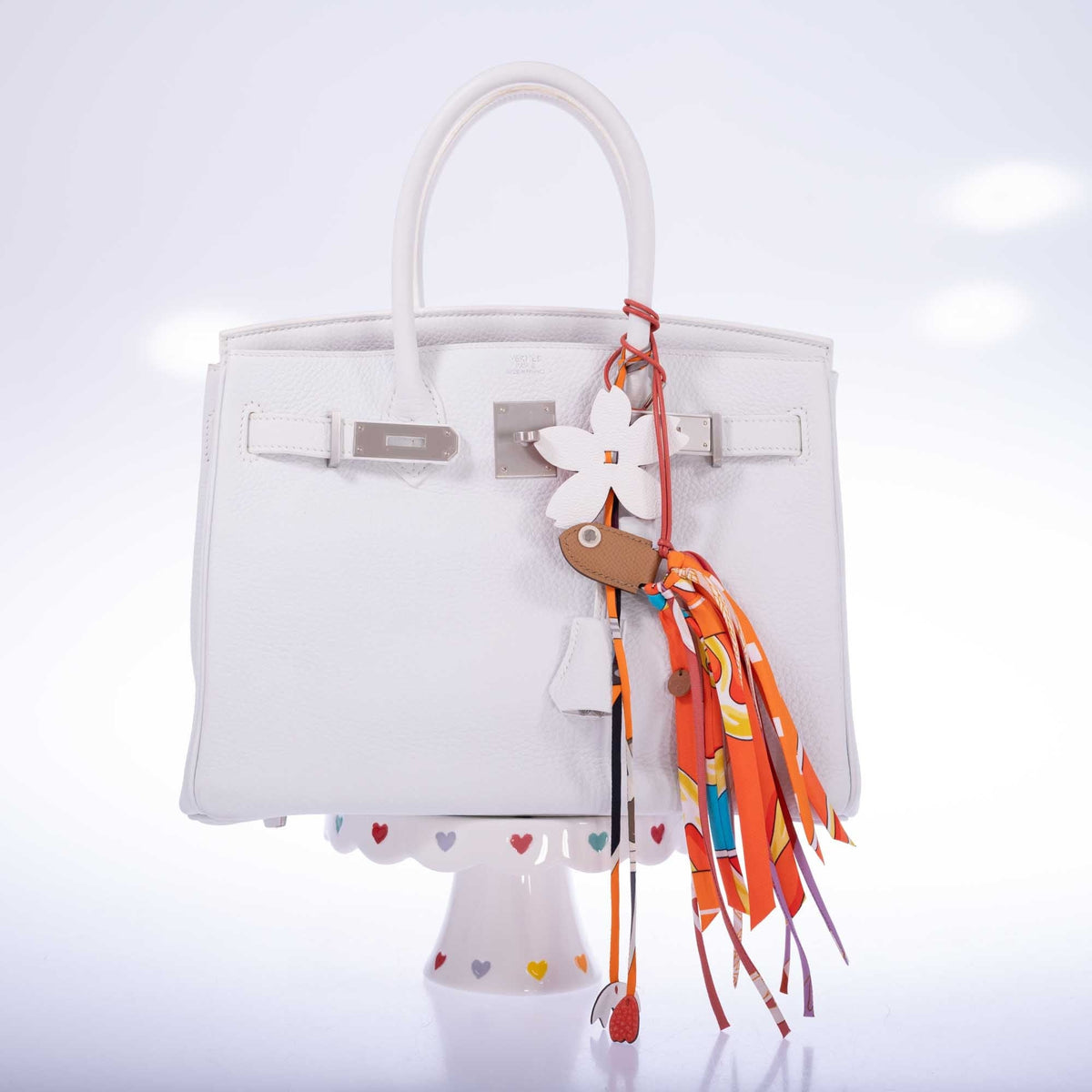 Hermès Birkin 30 HSS Blanc Clémence Brushed Palladium Hardware, front view with the flap open, shown with a flower charm and a twilly that are not included