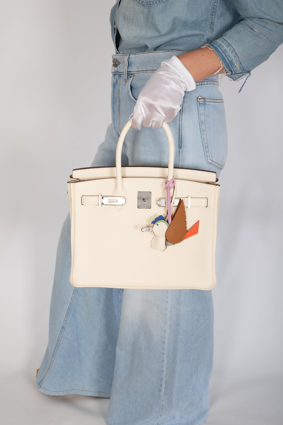 Hermès Birkin 30 Nata Togo Palladium Hardware, carried by the handles with the flap open, close view, styled with a bird charm, sold separately
