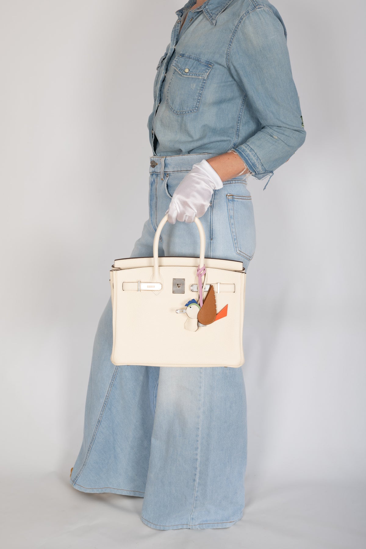 Hermès Birkin 30 Nata Togo Palladium Hardware, carried by the handles with the flap open, wider view showing scale, styled with a bird charm, sold separately