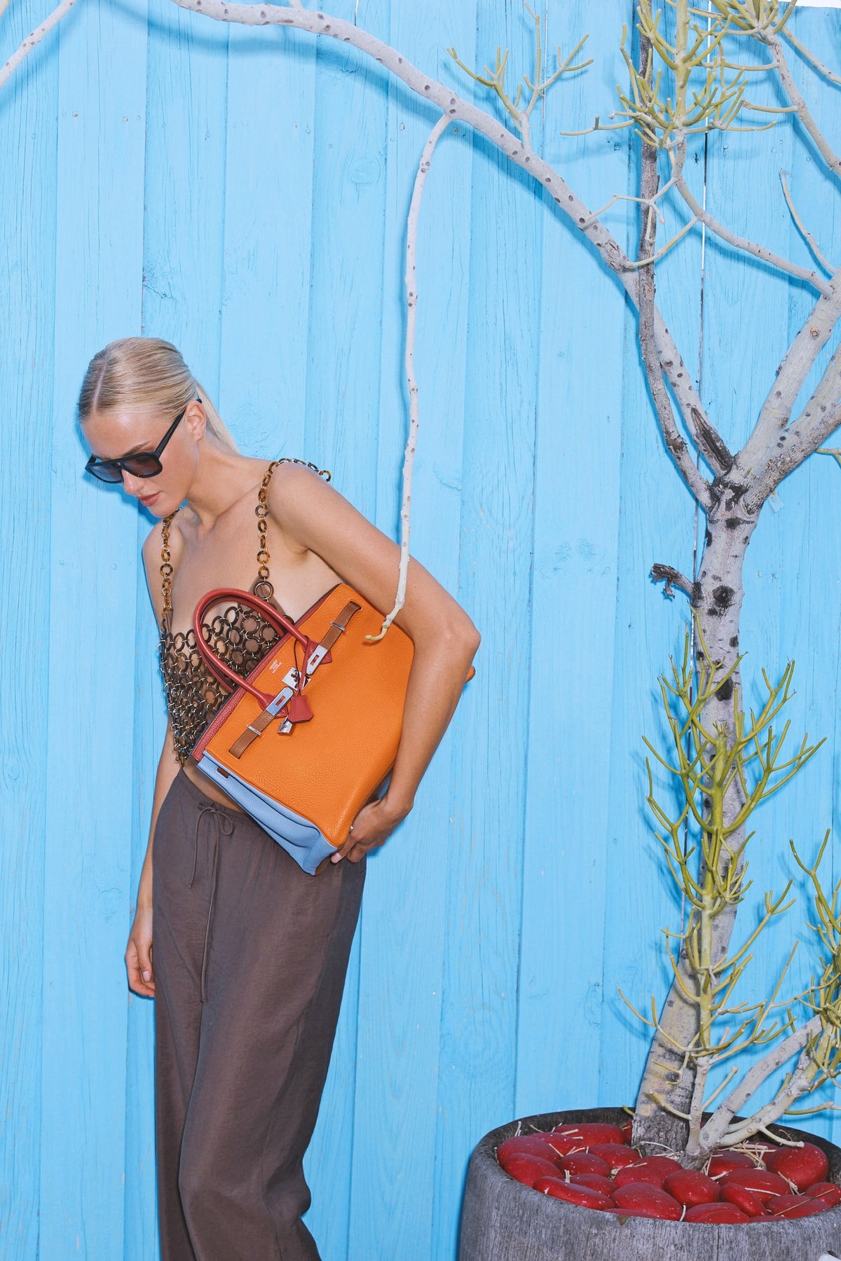 Hermès Birkin 35 Arlequin Clémence Palladium Hardware, carried under the arm by a model, looking down