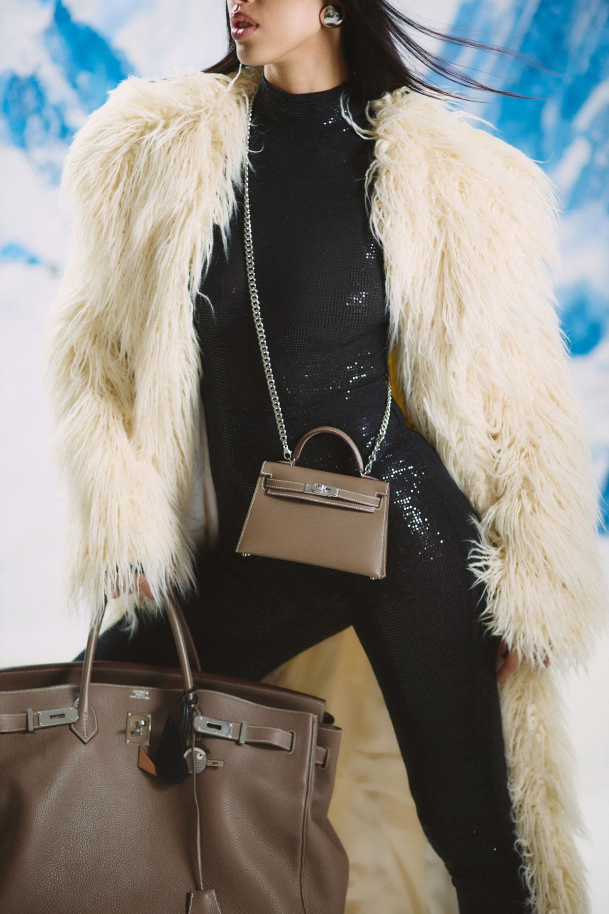 Hermès Birkin 50 Voyage Etoupe Clemence Palladium Hardware, carried by a model wearing a mini Kelly, close view