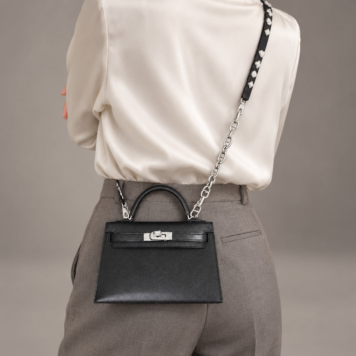 Hermès Clou de Coeur Kelly 20 Mini II Sellier Noir Chèvre Chamkila Palladium Hardware, front view worn crossbody with the JANEFINDS Convertible Triple Mariner Extender, sold separately