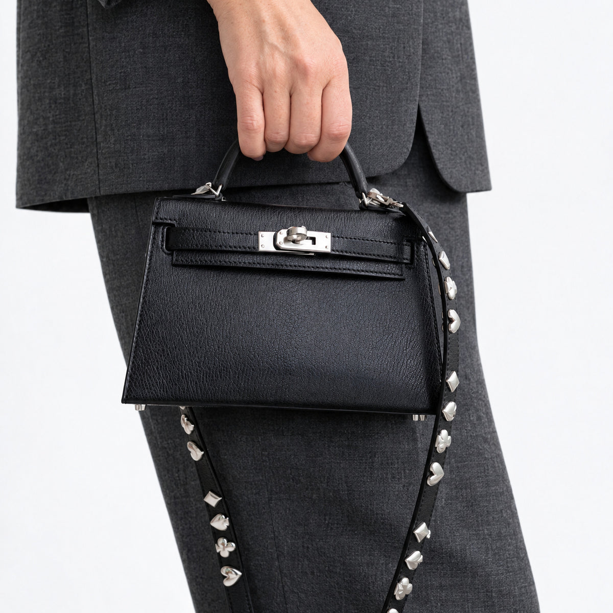 Hermès Clou de Coeur Kelly 20 Mini II Sellier Noir Chèvre Chamkila Palladium Hardware, carried by the top handle, close view