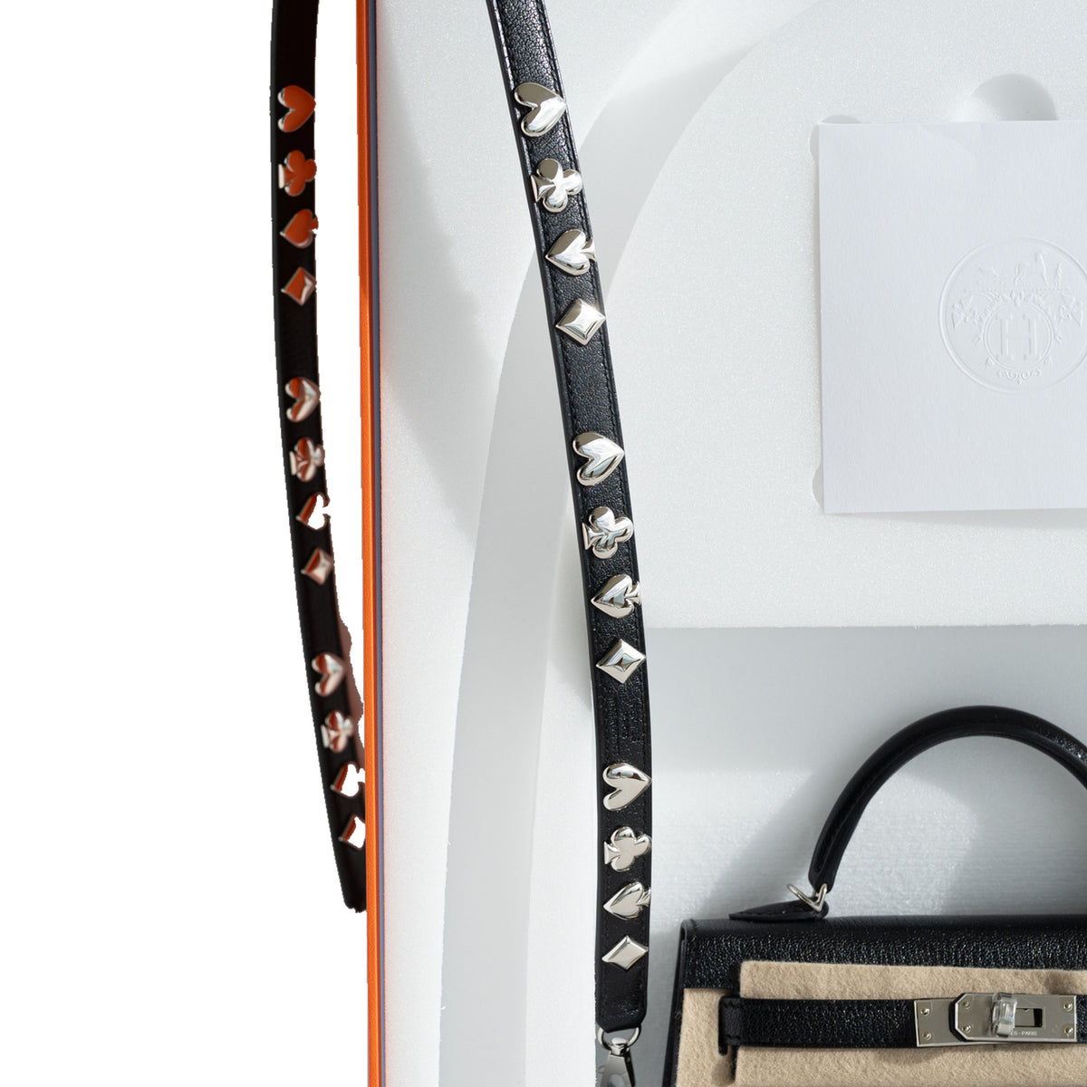 Hermès Clou de Coeur Kelly 20 Mini II Sellier Noir Chèvre Chamkila Palladium Hardware, studded strap detail with the Hermès packaging