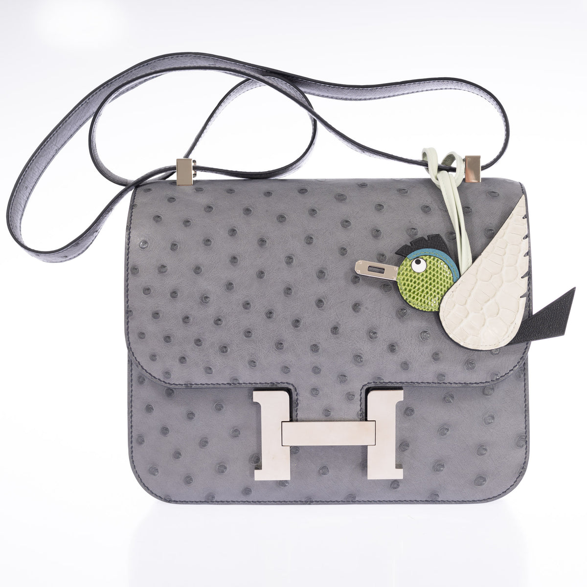Hermès Constance III 24 Gris Agate Ostrich Palladium Hardware, front view, styled with a charm, sold separately