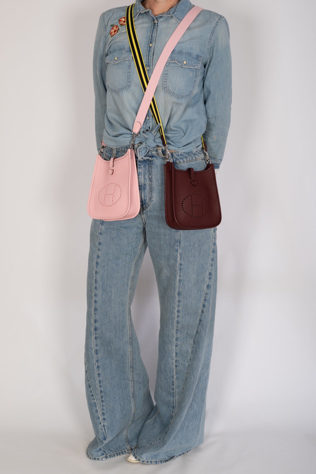 Hermès Evelyne 16 TPM Amazone Bordeaux Clémence Palladium Hardware worn beside a pink Evelyne, sold separately