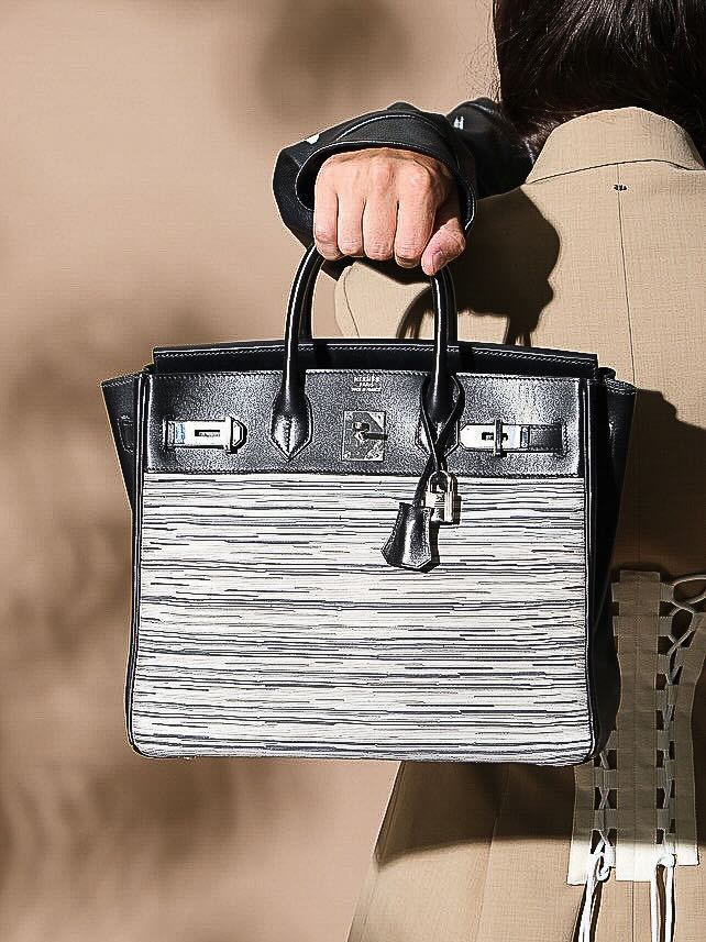 Hermès HAC Birkin 32 Vibrato and Noir Box Calf Palladium Hardware, carried by the handles by a model