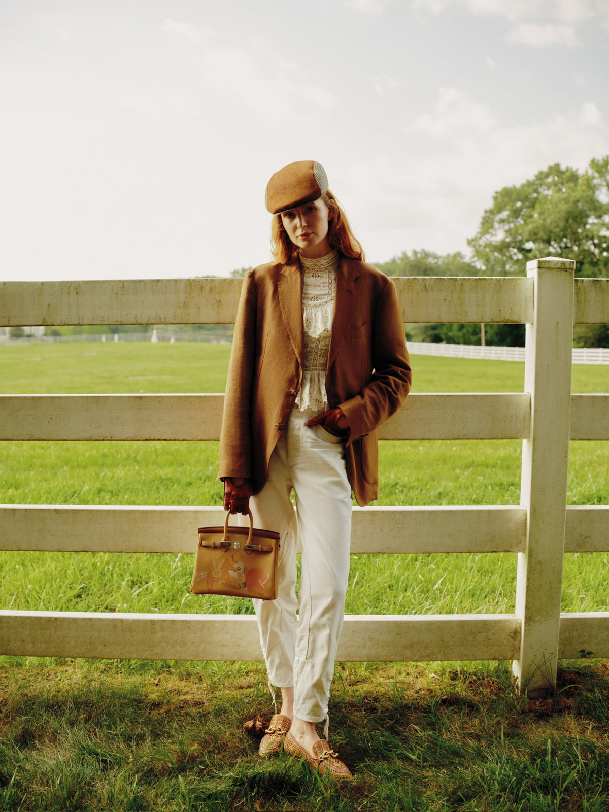 Hermès In and Out Birkin 25 Biscuit Printed Swift Palladium Hardware, carried by a model at a paddock fence