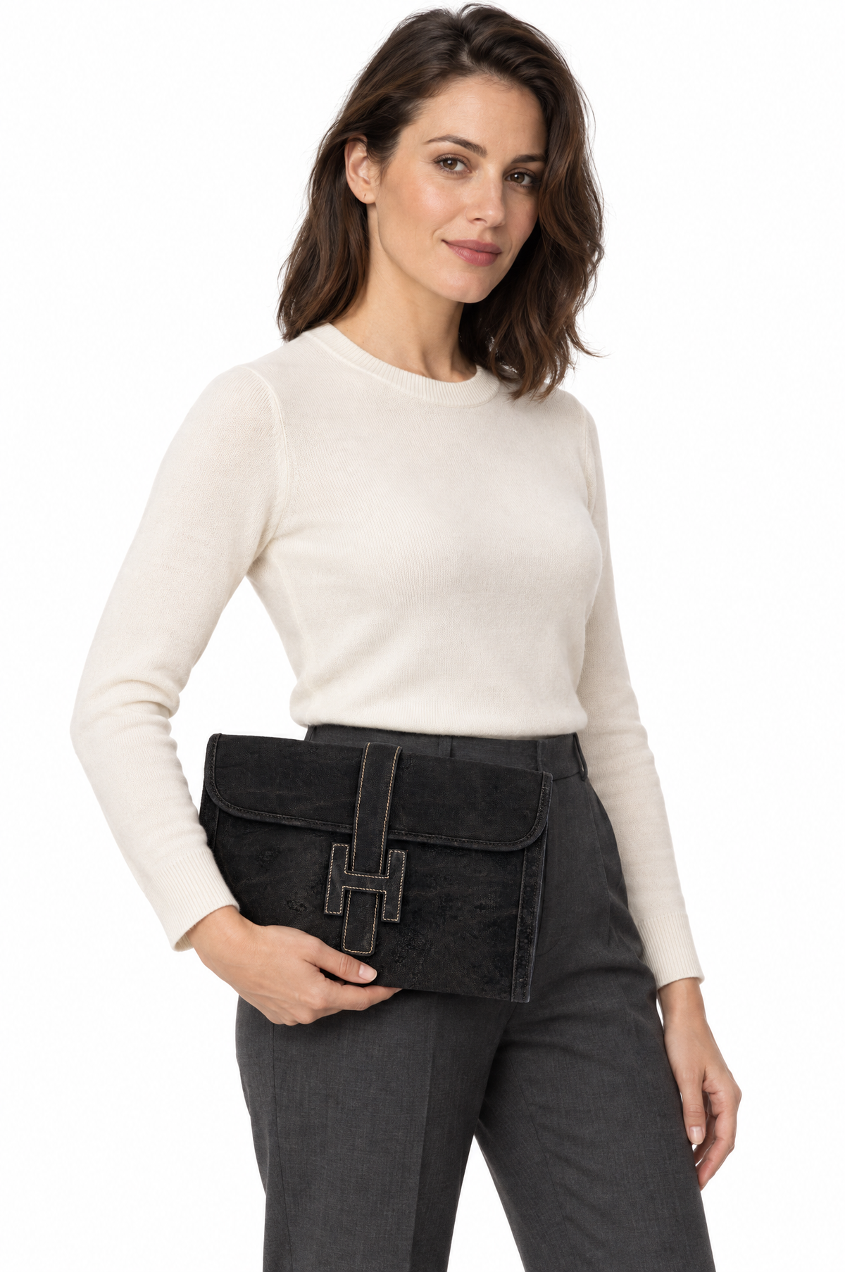 Hermès Jige 29 Noir Elephant, carried by a model at the hip, three-quarter view