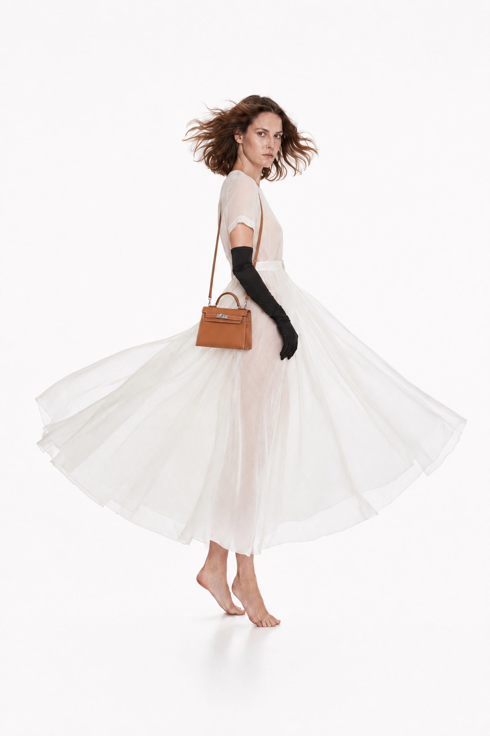 Hermès Mini Kelly 20 II Sellier in Gold Epsom with Palladium hardware, worn crossbody