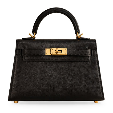 Hermès Kelly 20 Mini II Noir Epsom with Permabrass hardware, closed straight-on front view on white with a soft shadow beneath the bag.