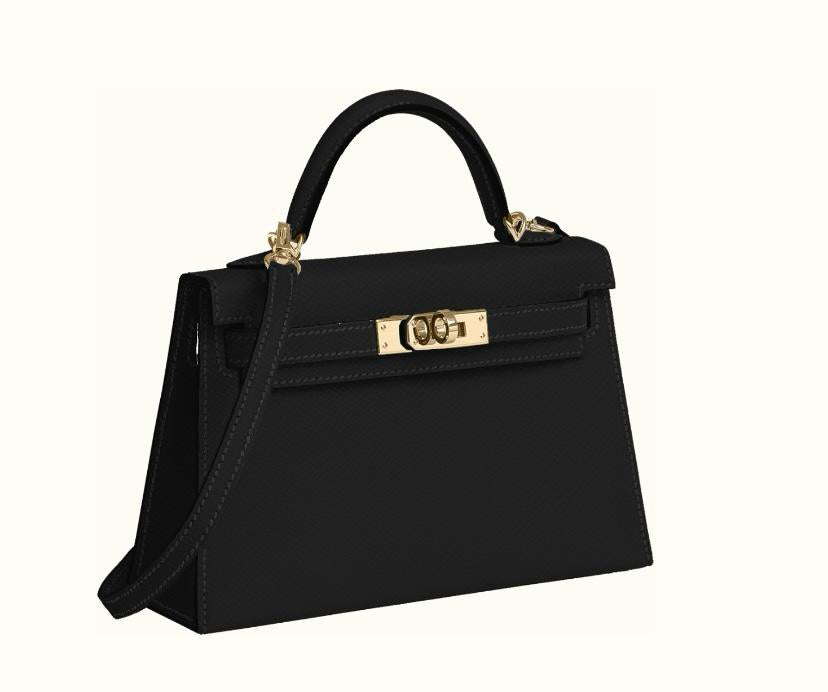 Hermès Kelly 20 Mini II HSS Verso Noir Epsom with Permabrass hardware, closed three-quarter view with its black leather shoulder strap.