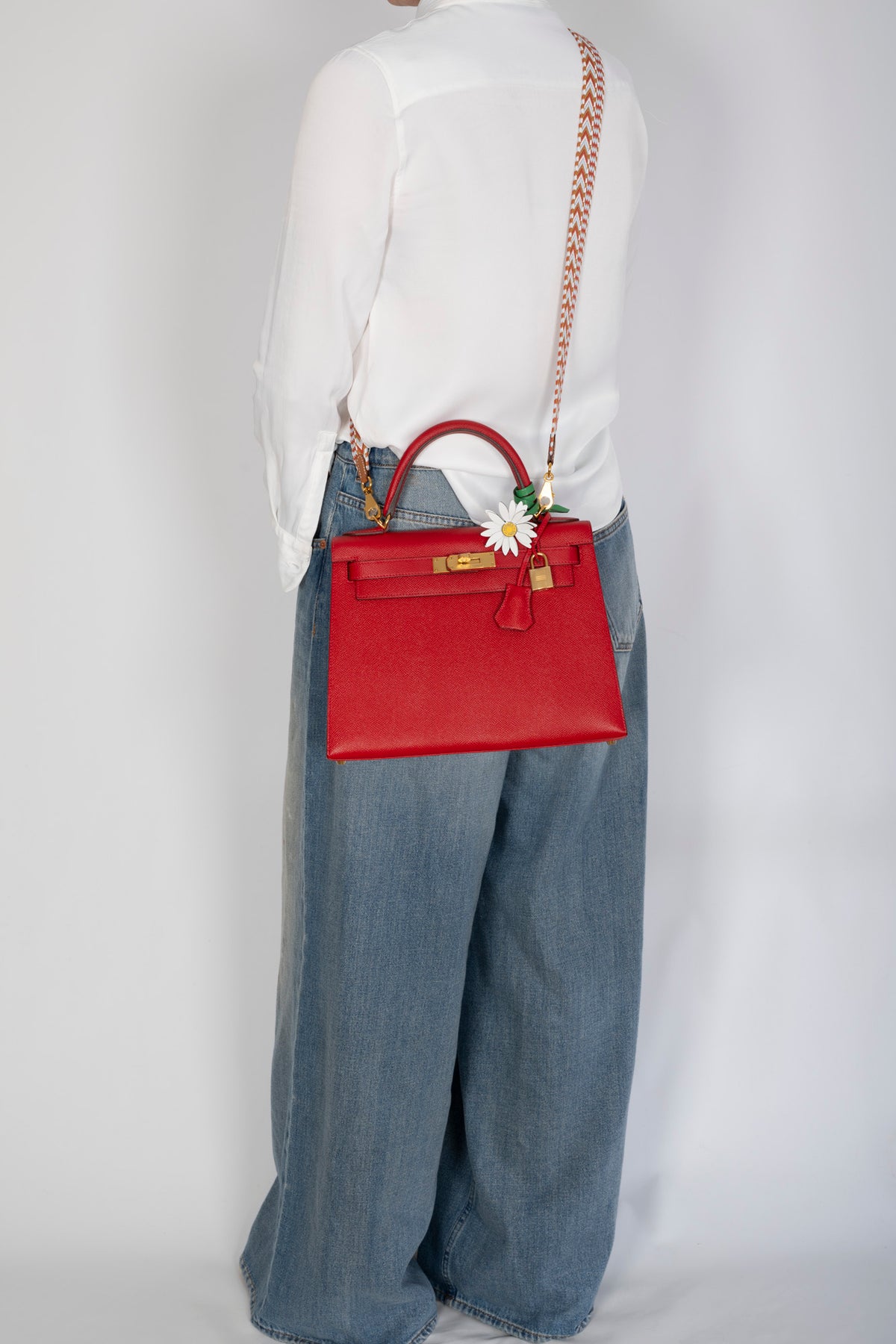Hermès Kelly 28 Sellier Rouge Casaque Epsom Gold Hardware, rear view worn crossbody by a model