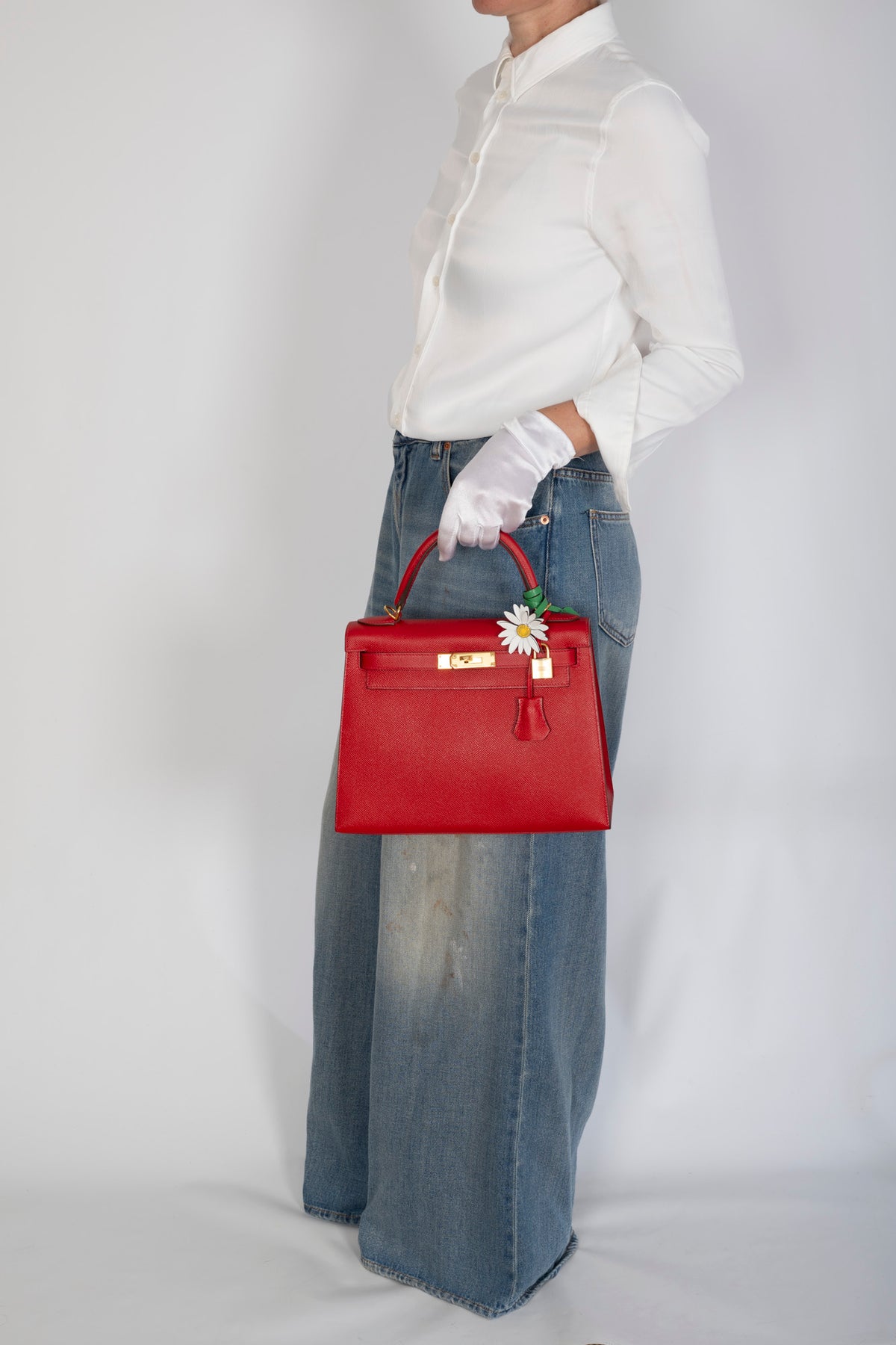 Hermès Kelly 28 Sellier Rouge Casaque Epsom Gold Hardware, carried at the side by a model