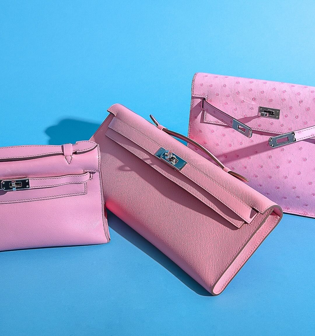 Hermès Kelly Cut Rose Confetti Epsom leather Palladium Hardware, flat lay beside other pink pieces