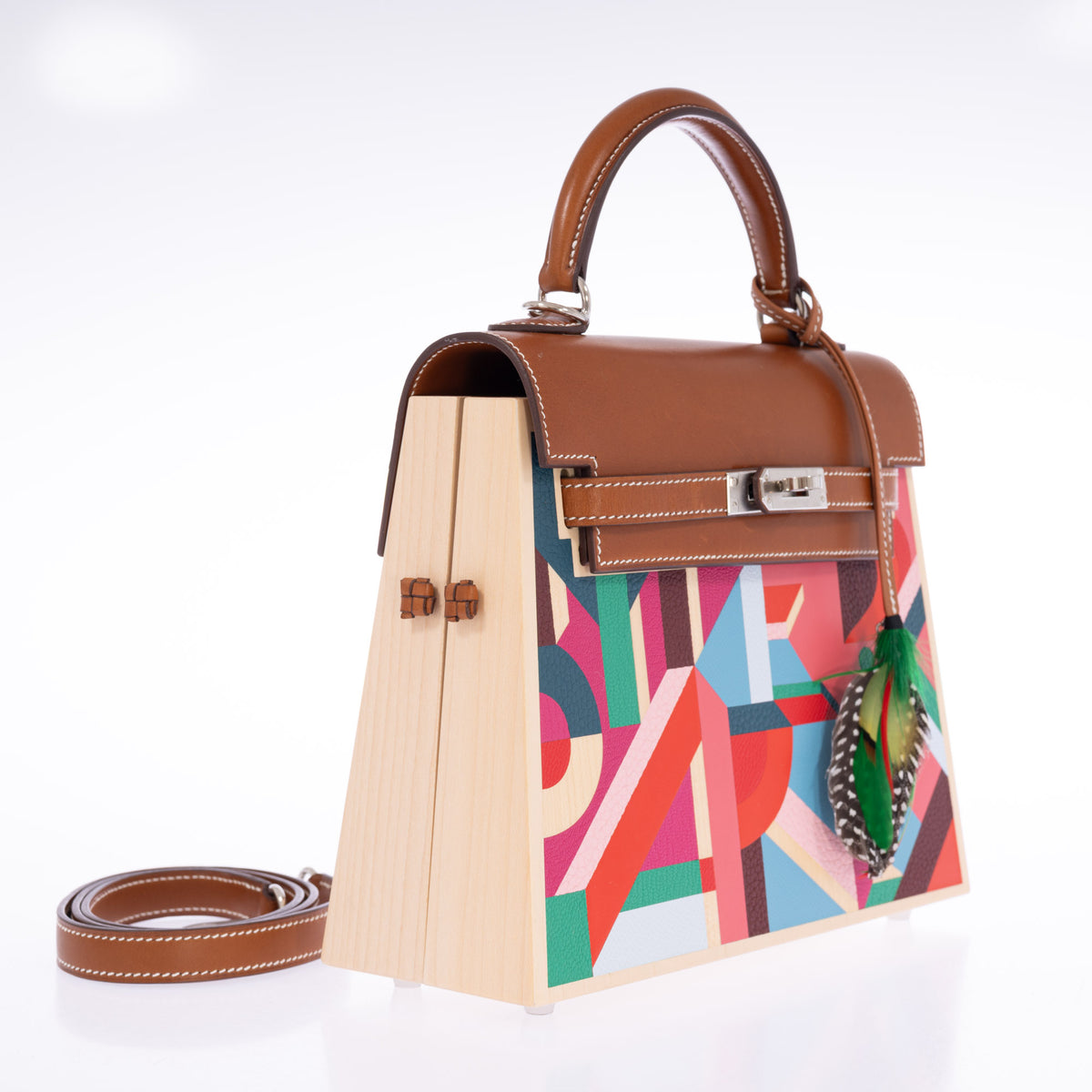 Hermès Kelly Picnic Kellywood Perspective Cavalière Wood Barenia Palladium Hardware, three-quarter view with the wood side and shoulder strap, styled with a feather charm, sold separately