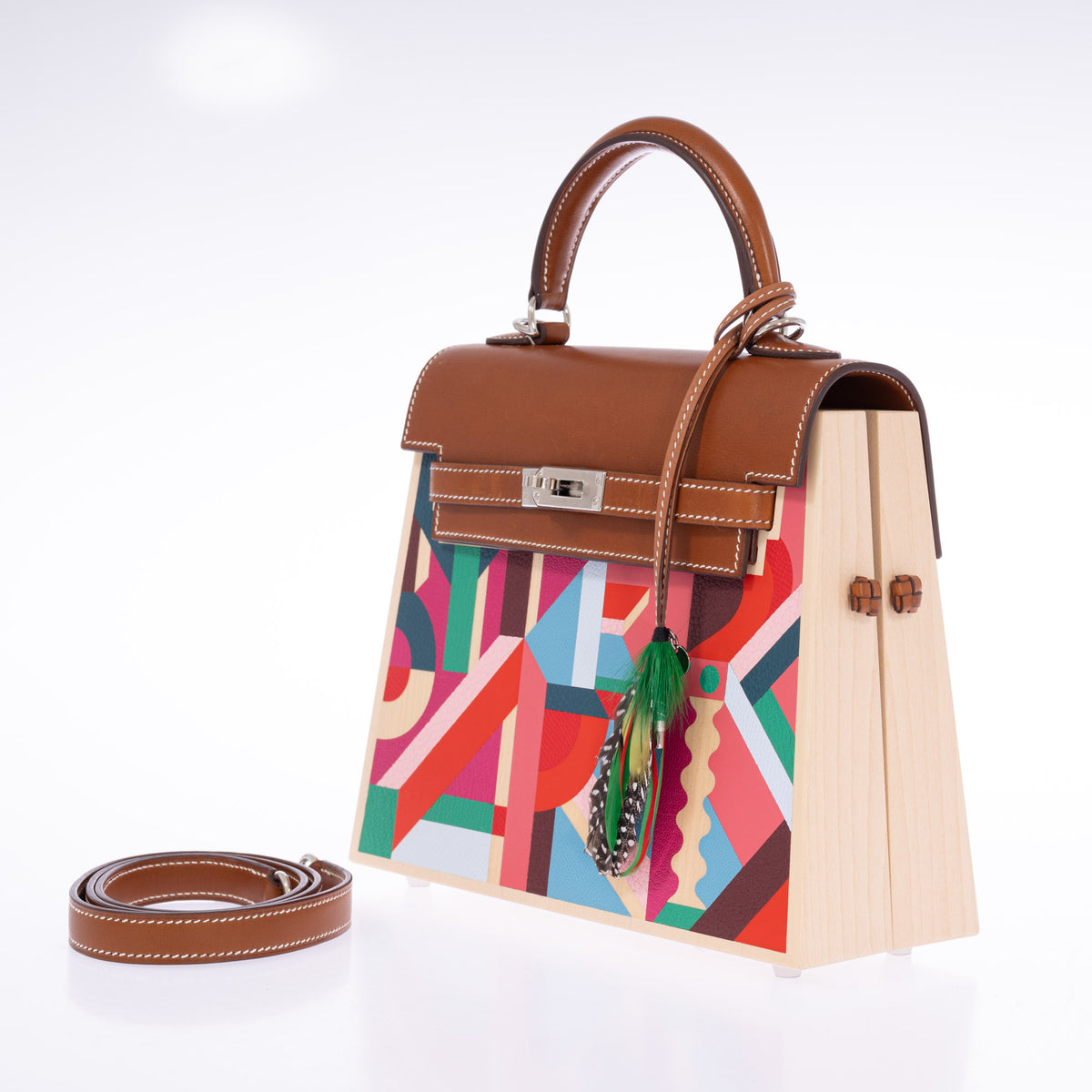 Hermès Kelly Picnic Kellywood Perspective Cavalière Wood Barenia Palladium Hardware, opposite three-quarter view with the wood side toggles and shoulder strap, styled with a feather charm, sold separately