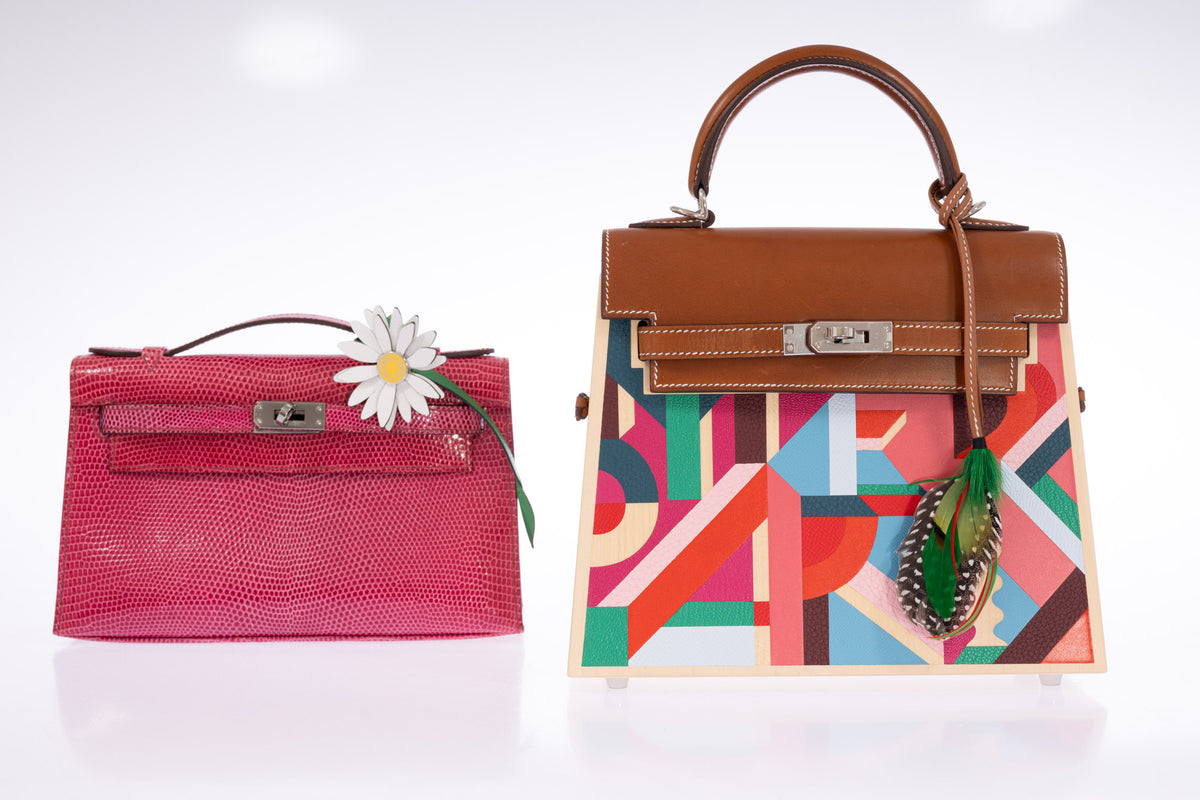 Hermès Kelly Picnic Kellywood Perspective Cavalière Wood Barenia Palladium Hardware, beside a pink lizard Kelly Pochette with a daisy charm, styled with a feather charm, all sold separately