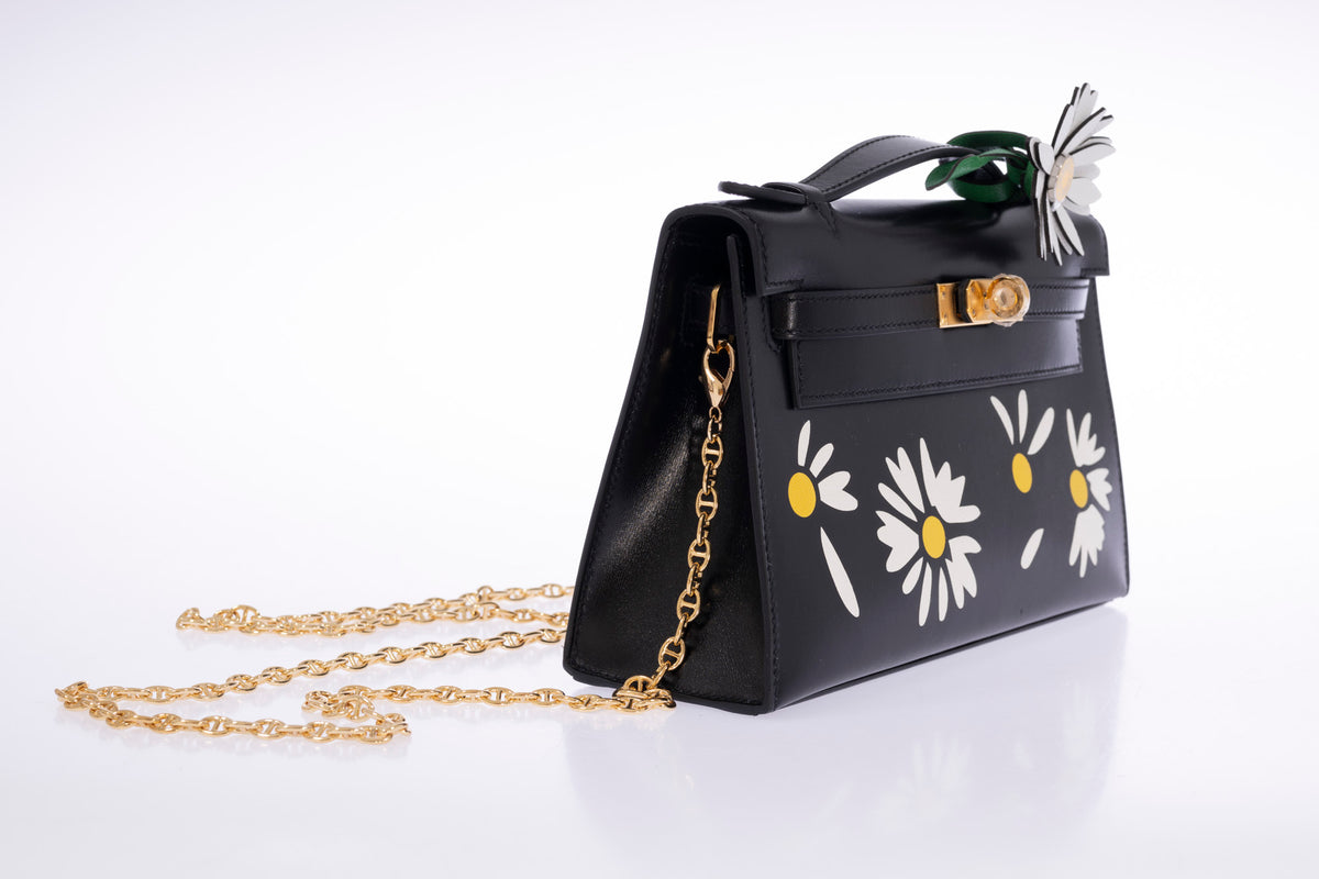 Hermès Kelly Pochette Marqueterie Marguerite Noir Box Gold Hardware, three-quarter view with a shoulder chain attached, chain sold separately