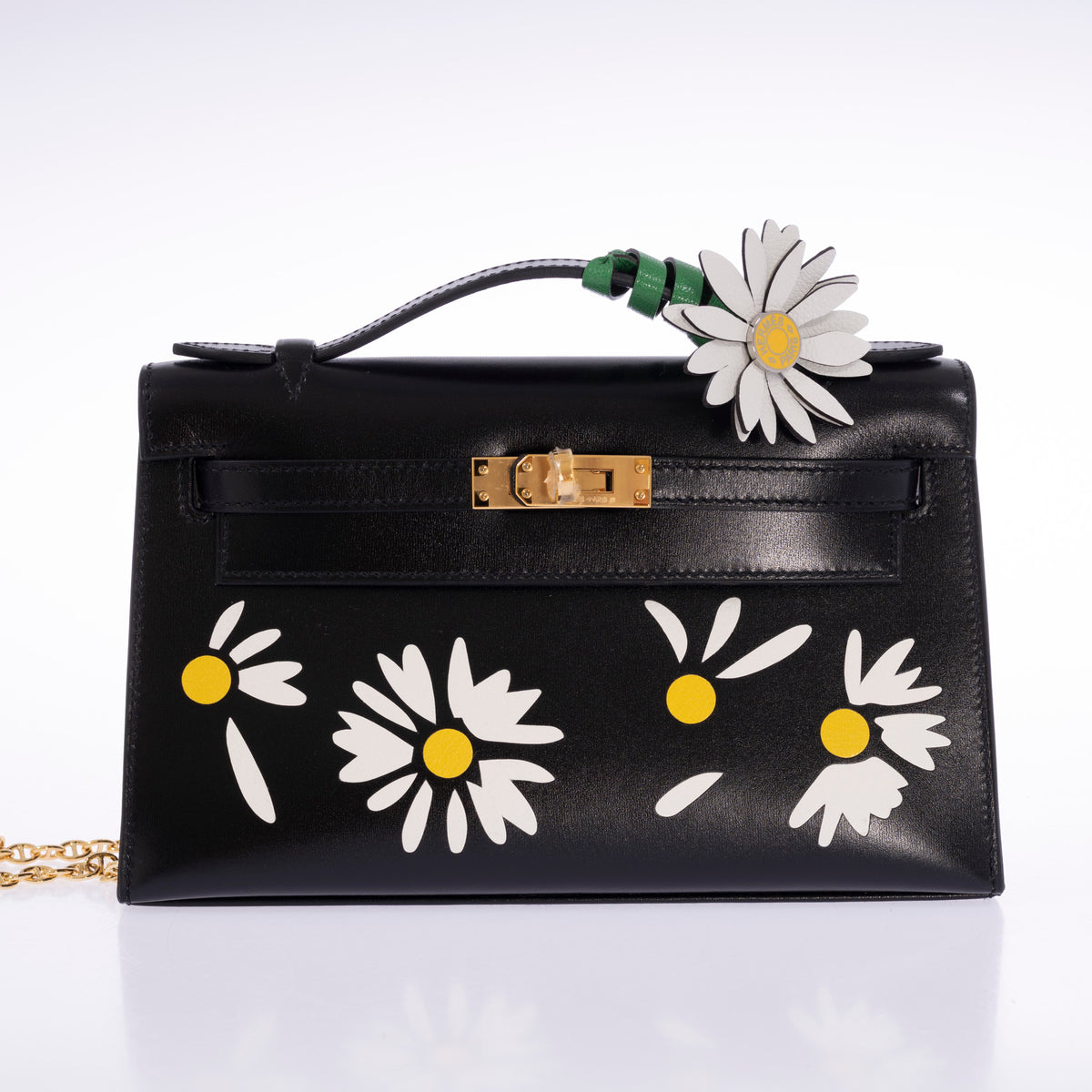 Hermès Kelly Pochette Marqueterie Marguerite Noir Box Gold Hardware, front view with a marguerite charm and shoulder chain, charm and chain sold separately