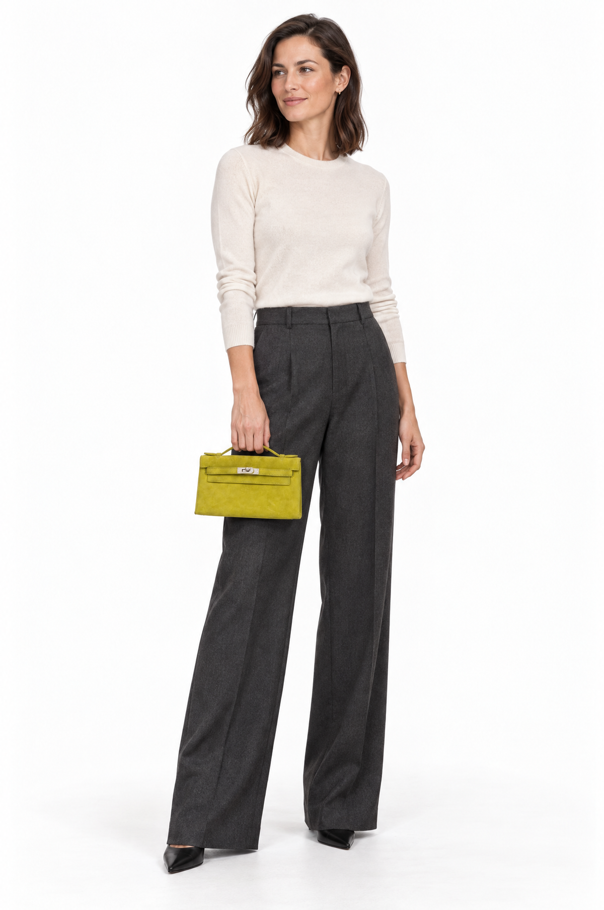 Hermès Kelly Pochette Vert Anis Veau Doblis Suede Palladium Hardware, carried by a model by its handle, full length