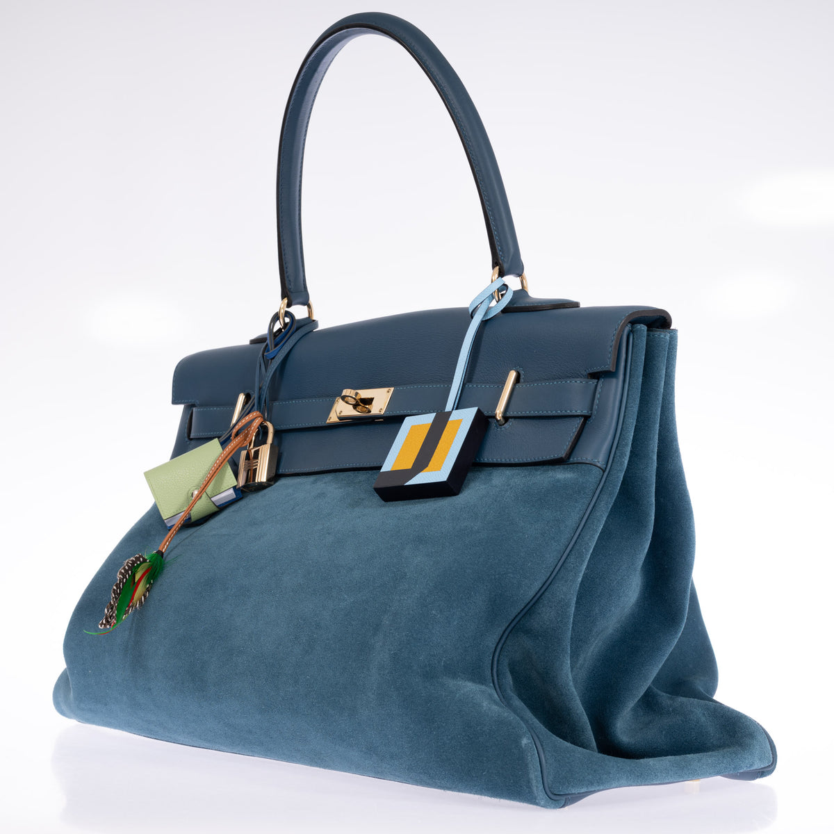 Hermès Kelly Relax 50 Grizzly Bleu Thalassa Doblis Suede and Swift Permabrass Hardware, three-quarter view of the suede gusset and Swift flap, styled with charms, sold separately