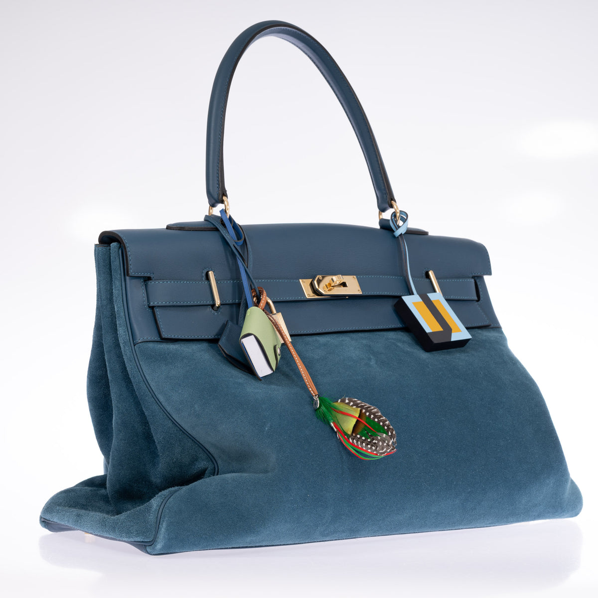 Hermès Kelly Relax 50 Grizzly Bleu Thalassa Doblis Suede and Swift Permabrass Hardware, three-quarter view from the left with padlock and clochette, styled with charms, sold separately