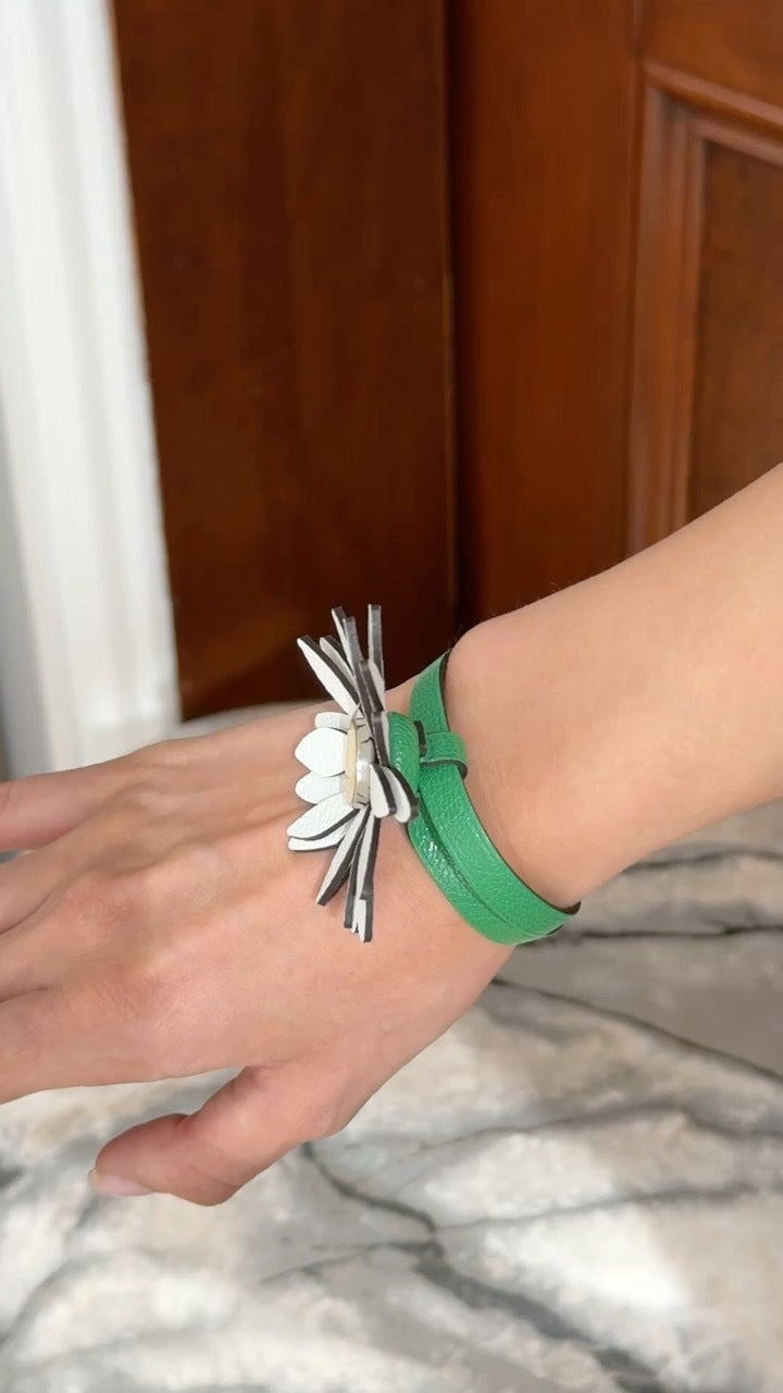 Hermès Marguerite Daisy Charm White Jaune de Naples Bambou, strap wrapped around the wrist like a bracelet