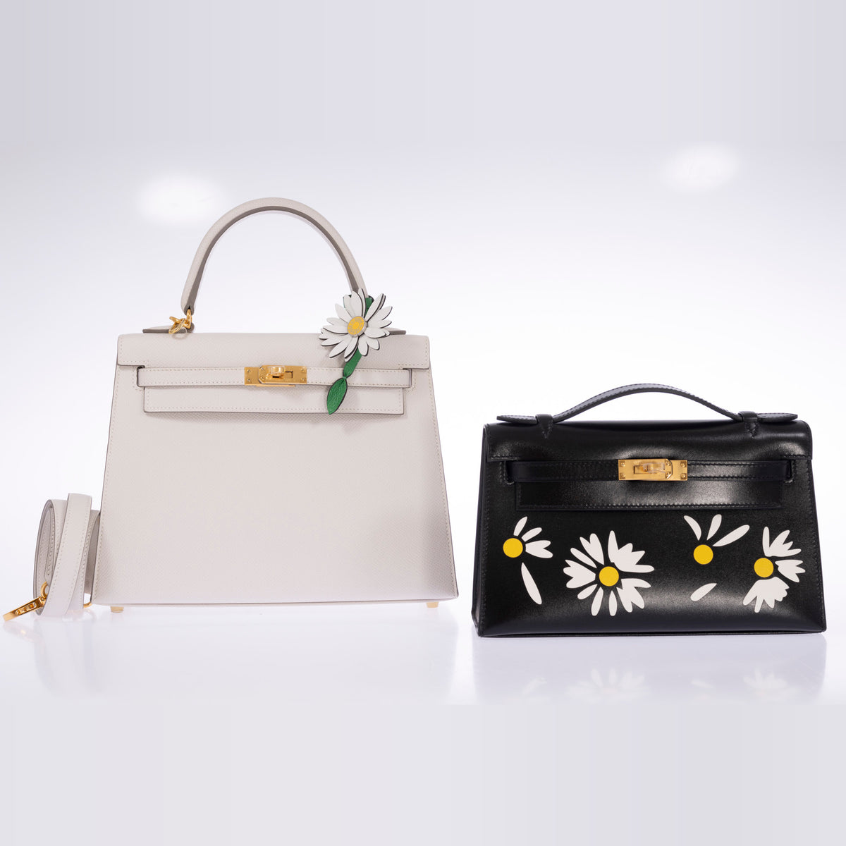 Hermès Marguerite Daisy Charm White Jaune de Naples Bambou, on the handle of a white Kelly Sellier shown beside a Kelly Pochette, bags sold separately