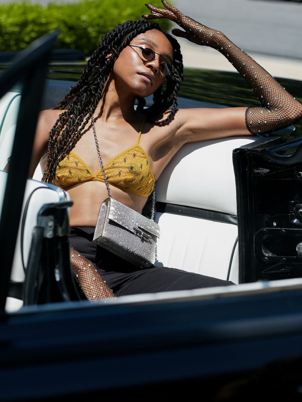 Hermès Mini Verrou Chain 18 Ombre Lizard Palladium Hardware, worn crossbody on a chain by a model seated in a car