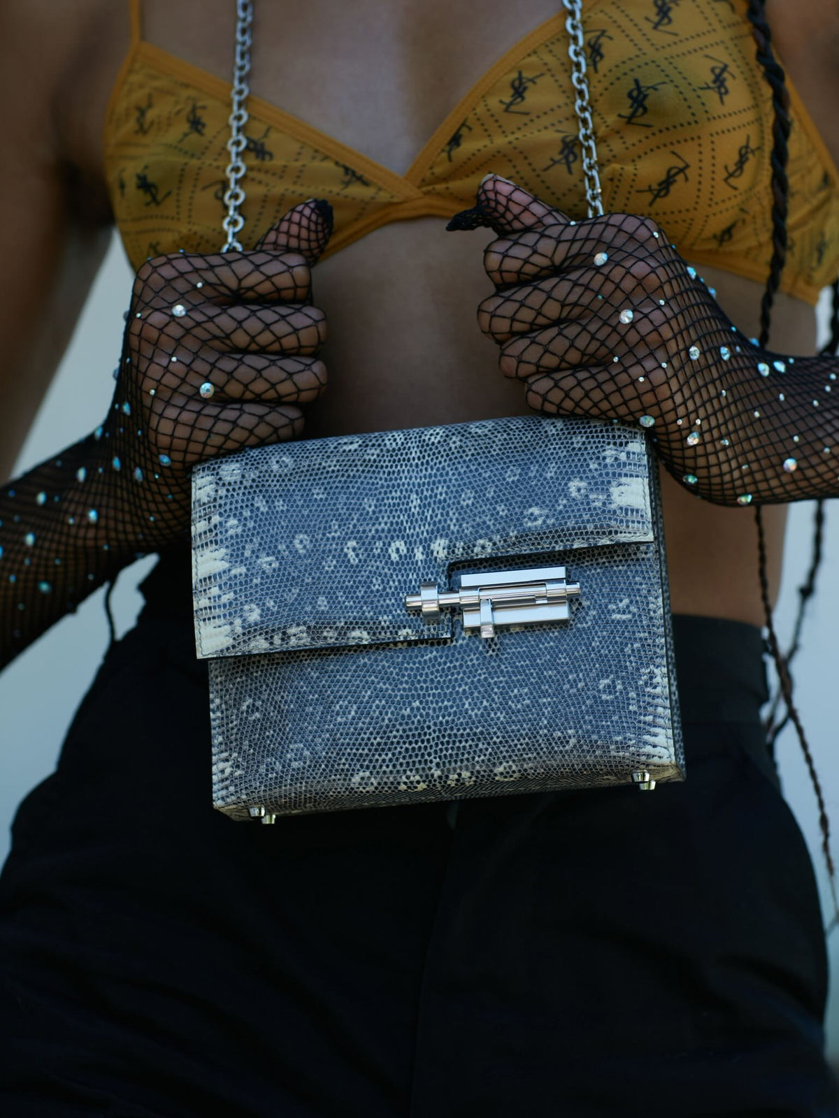Hermès Mini Verrou Chain 18 Ombre Lizard Palladium Hardware, held by a model in fishnet gloves, close view