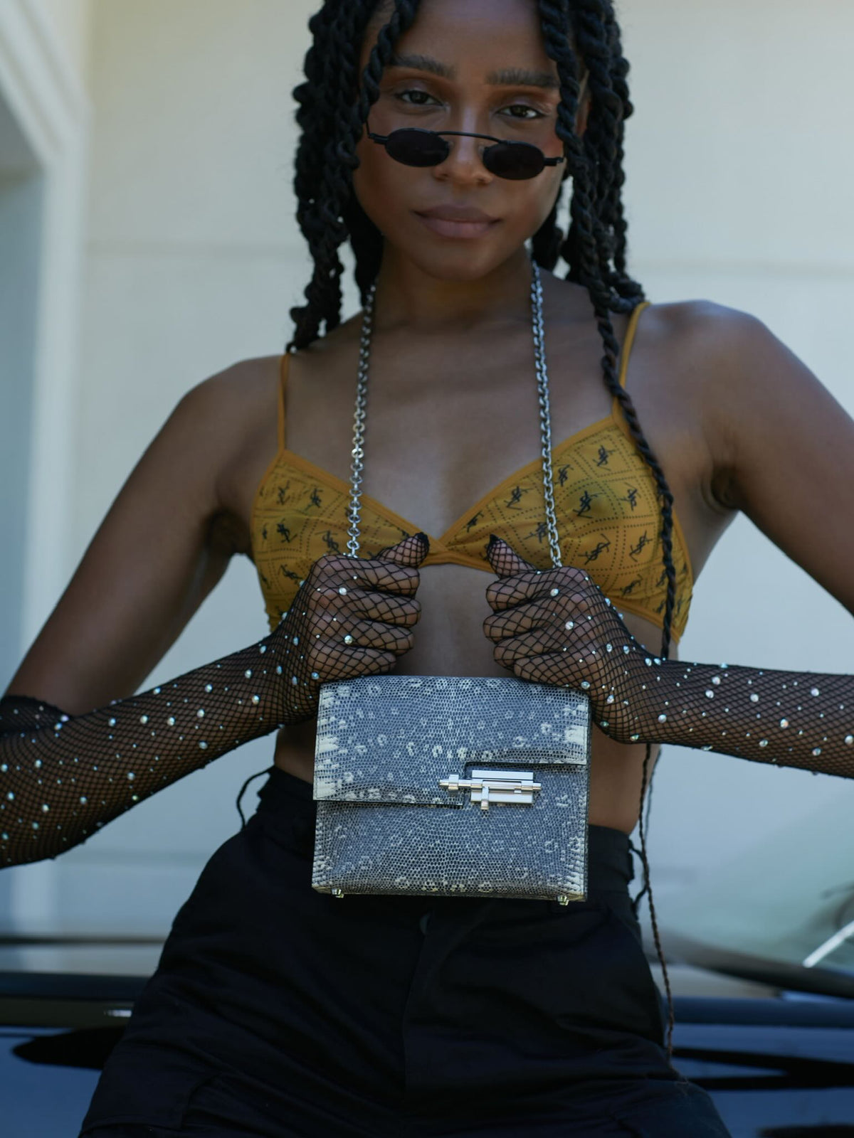 Hermès Mini Verrou Chain 18 Ombre Lizard Palladium Hardware, held by a model in fishnet gloves