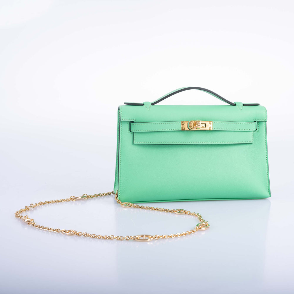 JaneFinds Mariner Crossbody Chain in gold, with anchor links alternating with fine cable sections, styled with a mint green Hermes Kelly bag.