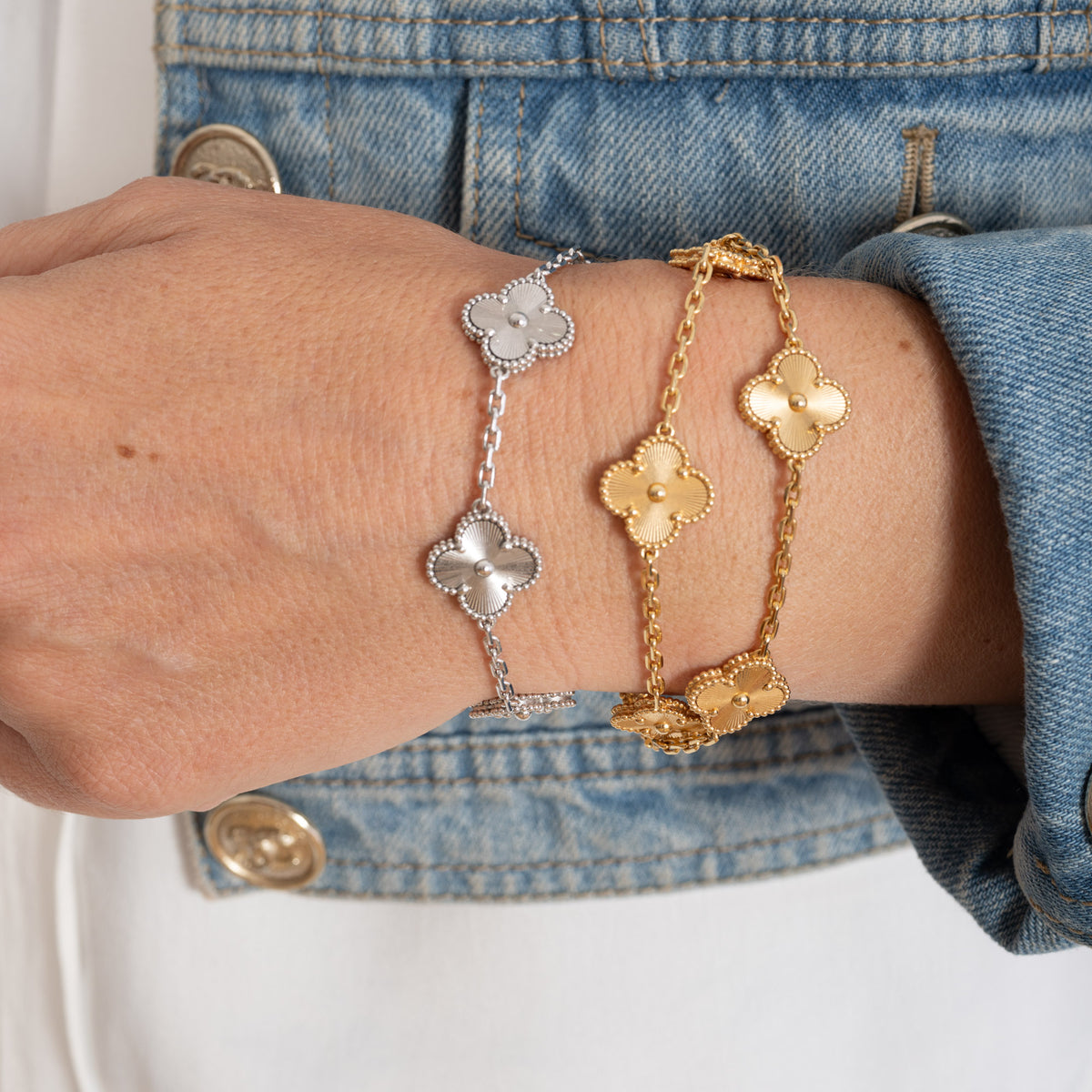 Van Cleef & Arpels Vintage Alhambra 5-Motif Guilloché Bracelet 18K White Gold, worn on the wrist, styled with yellow gold bracelets that are not included