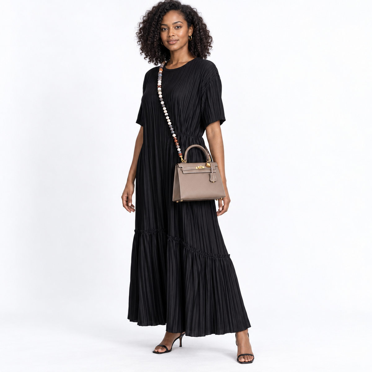 Hermès Kelly 25 Sellier Etoupe Epsom with Gold Hardware modeled in a white studio