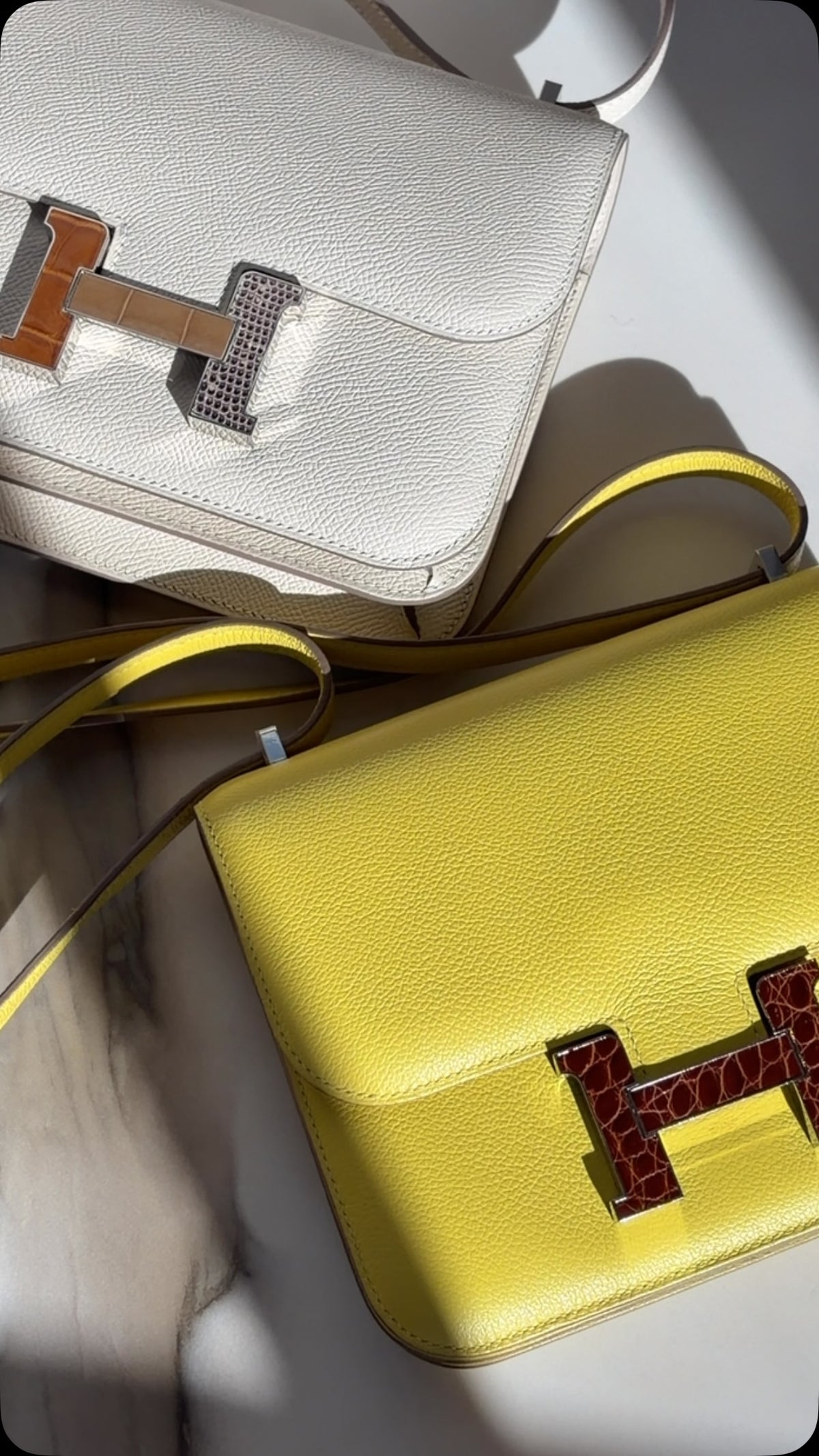 JANEFINDS Instagram: Constance 18 in Lime Evergrain with Miel Alligator hardware beside a Constance 18 Mini III Mirror Bag in Craie Epsom on marble