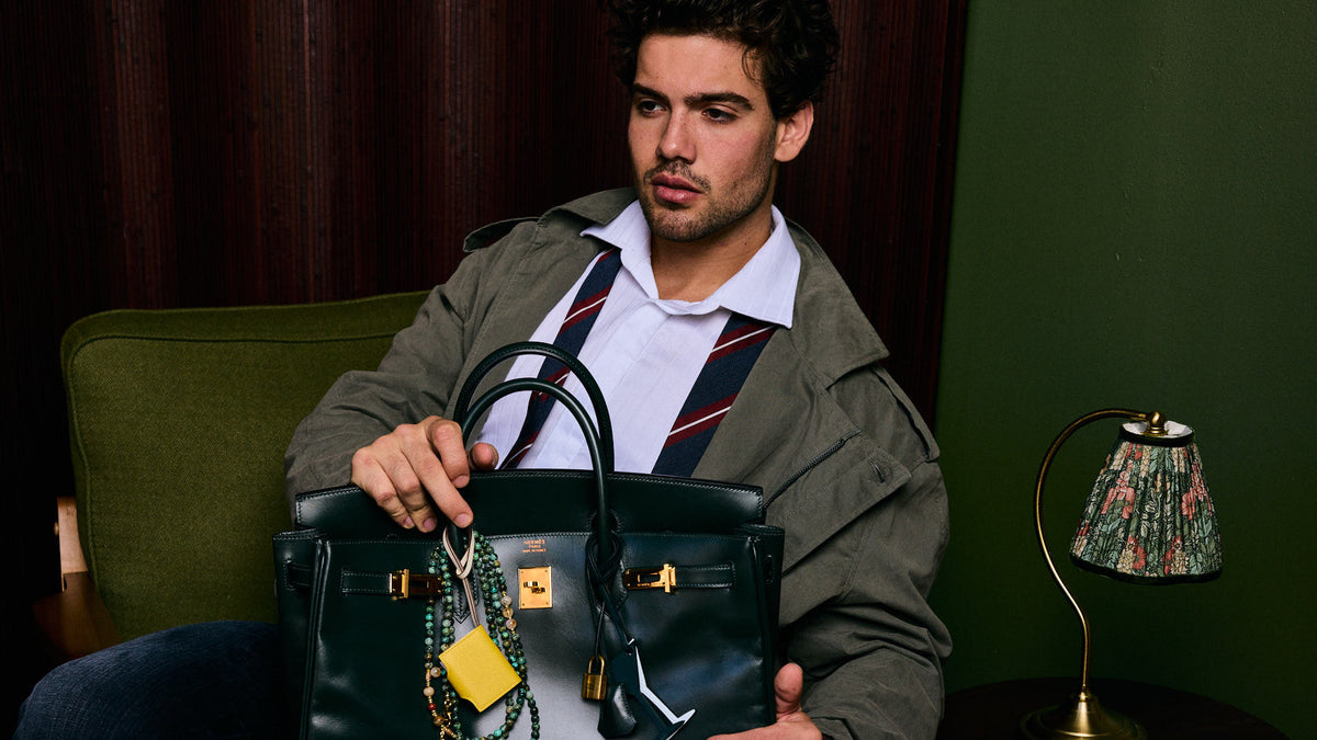 Hermès Birkin 40 in Vert Anglais Box calf with gold hardware, held by a seated model