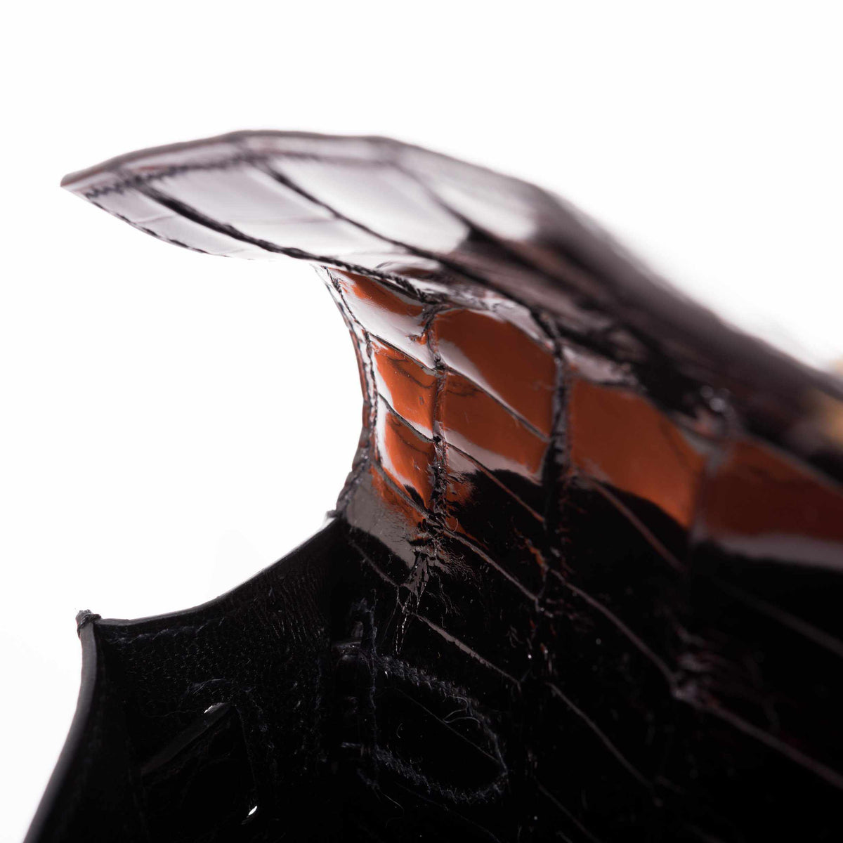 Hermès Kelly Cut Noir Shiny Porosus Crocodile Gold Hardware, flap lifted to show its edge and underside