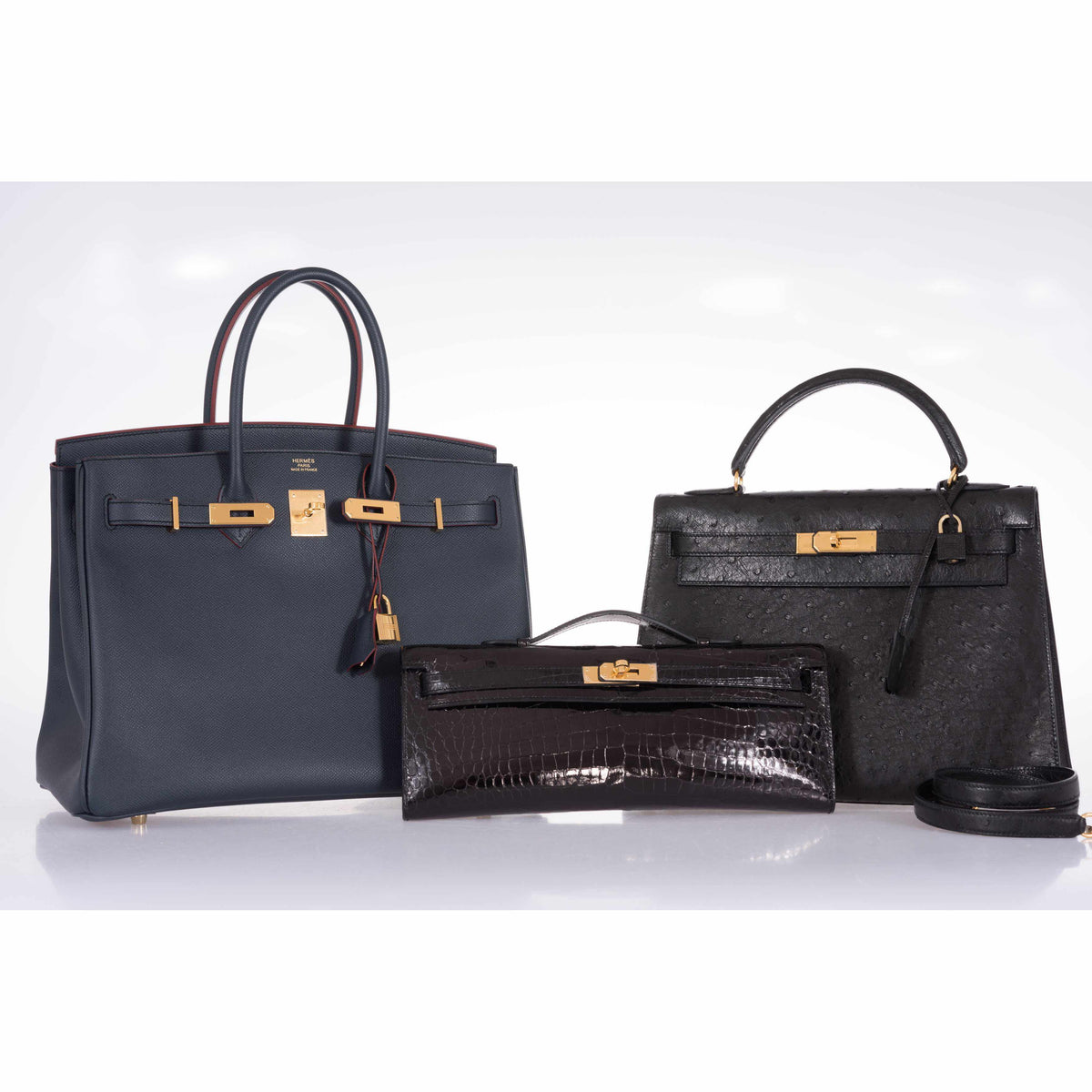 Hermès Kelly Cut Noir Shiny Porosus Crocodile Gold Hardware, shown with a Birkin and a Kelly that are not included